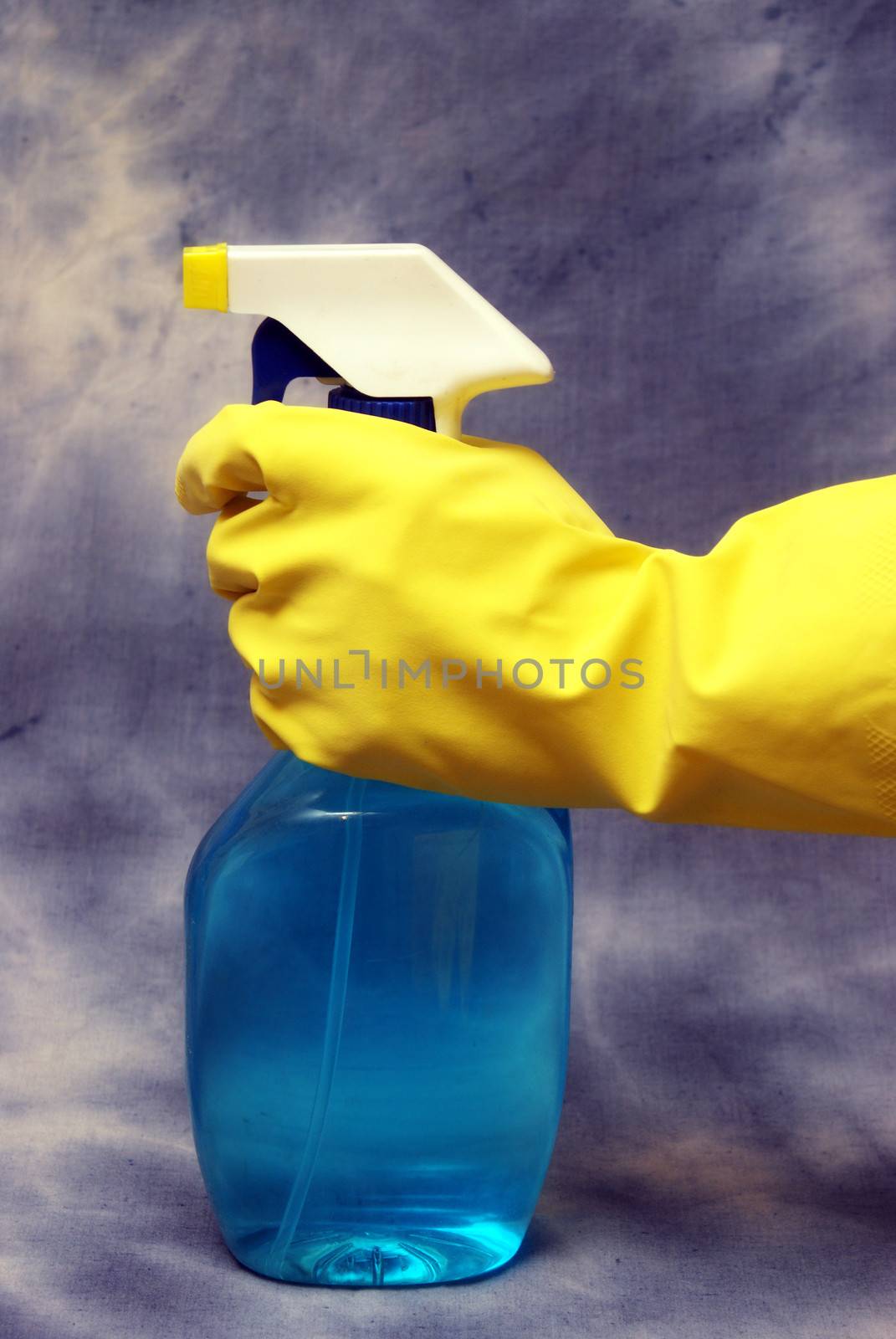 A cleaning person prepares to clean using a spray bottle.