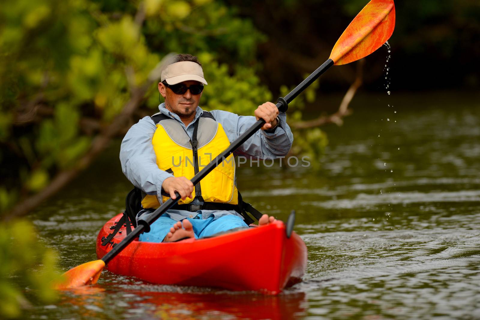 young man in kayak in a tropical location