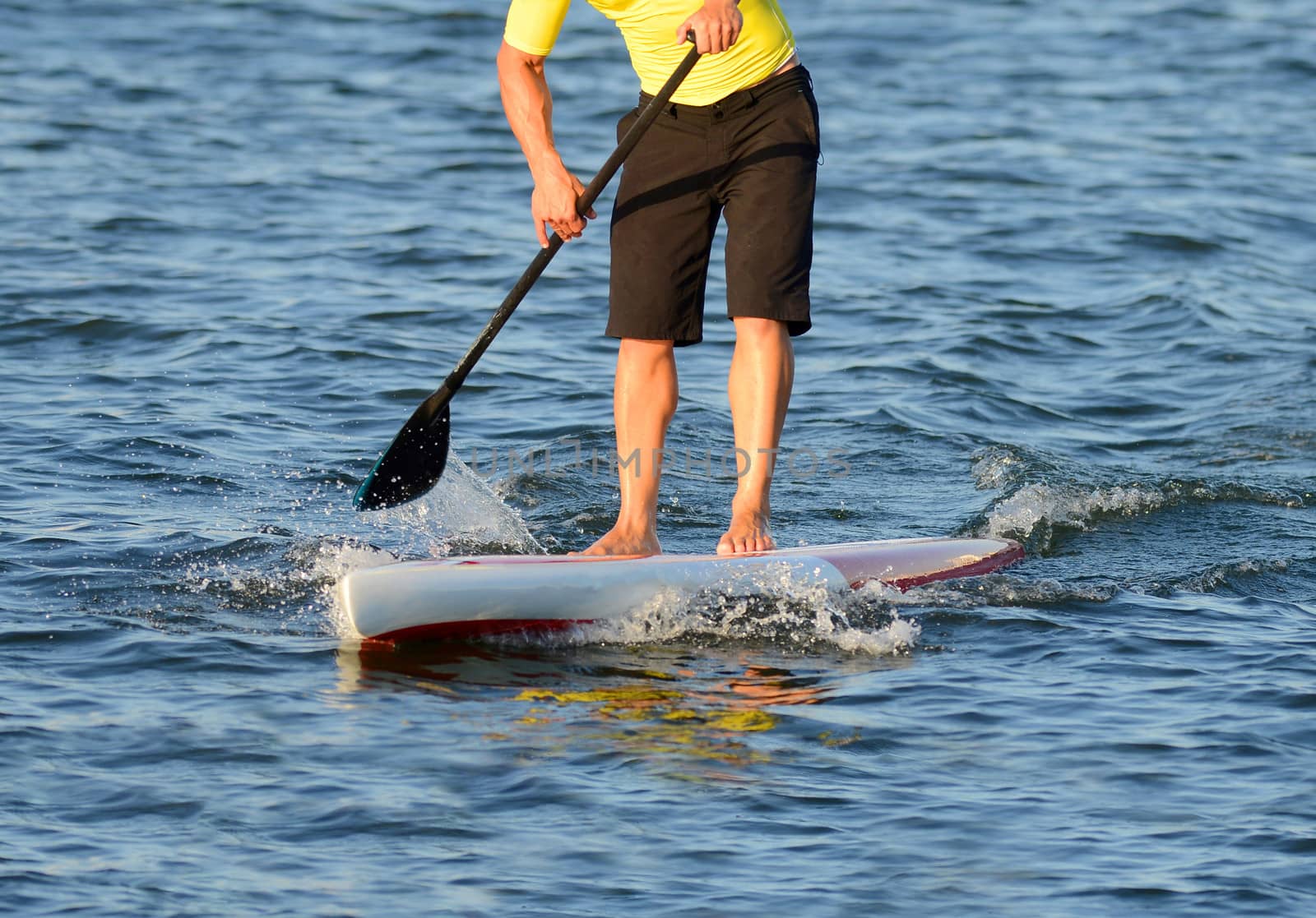 man on a paddle board in ocean by ftlaudgirl