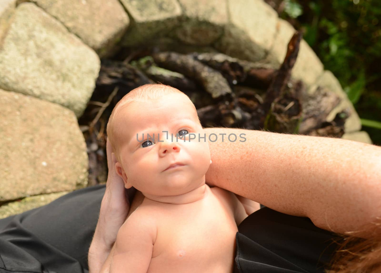 mom holding newborn baby outside by ftlaudgirl