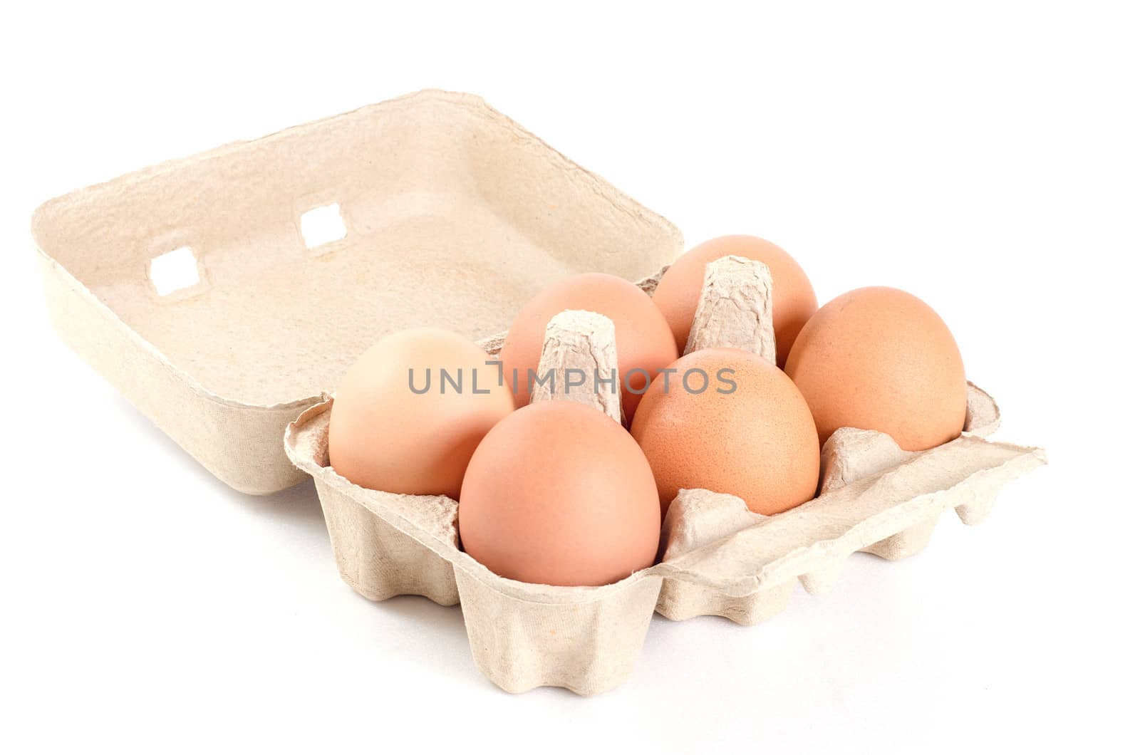 eggs in cardboard tray on white background with clipping path