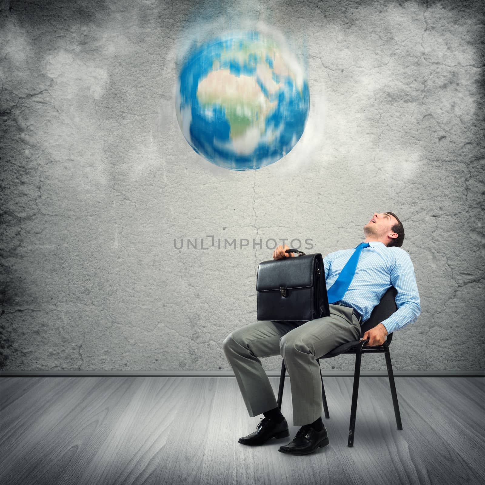 image of a business man looking at the falling planet. Elements of this image furnished by NASA