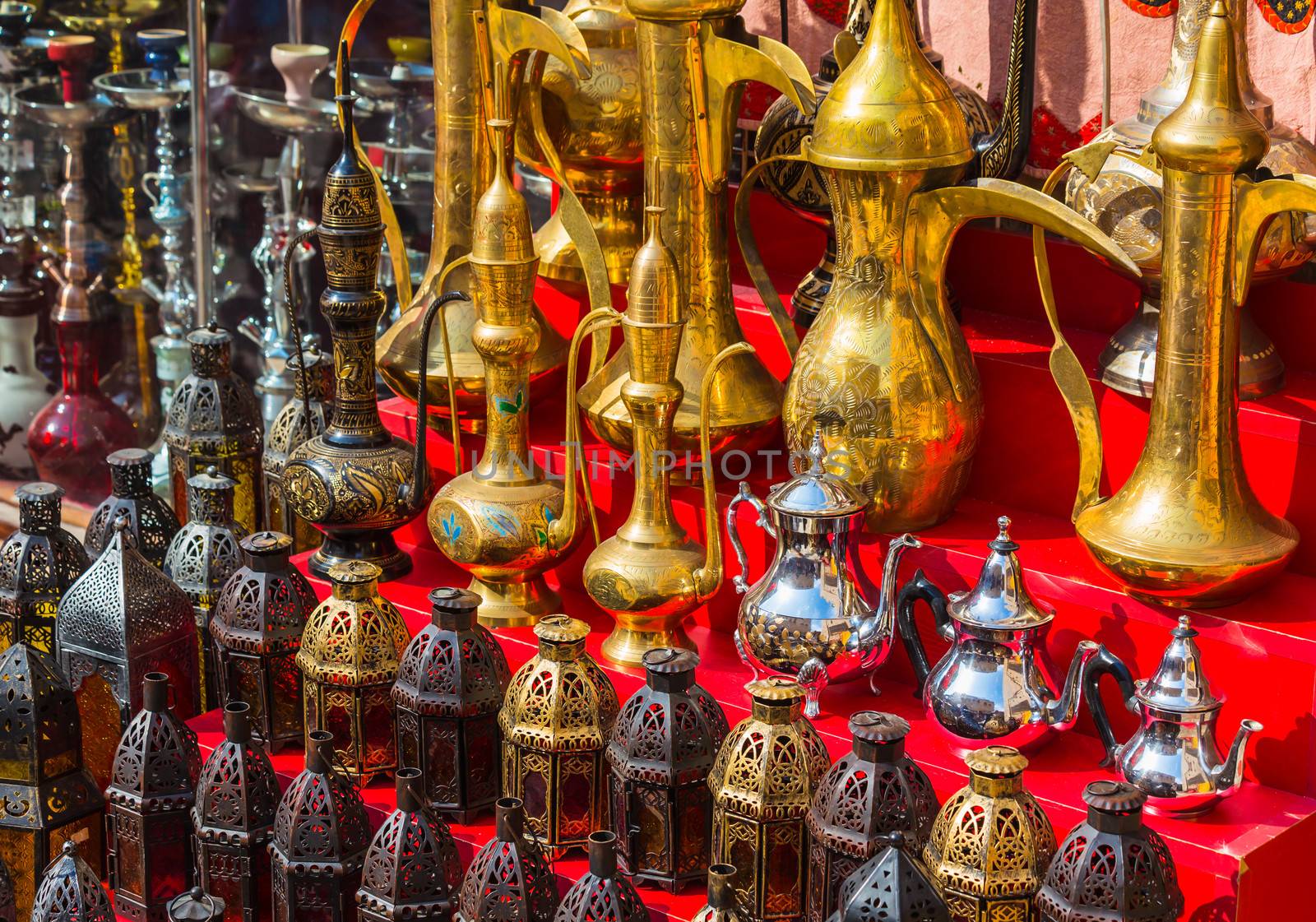 row of shiny traditional coffee pots and lamp at the souq in Dubai.
