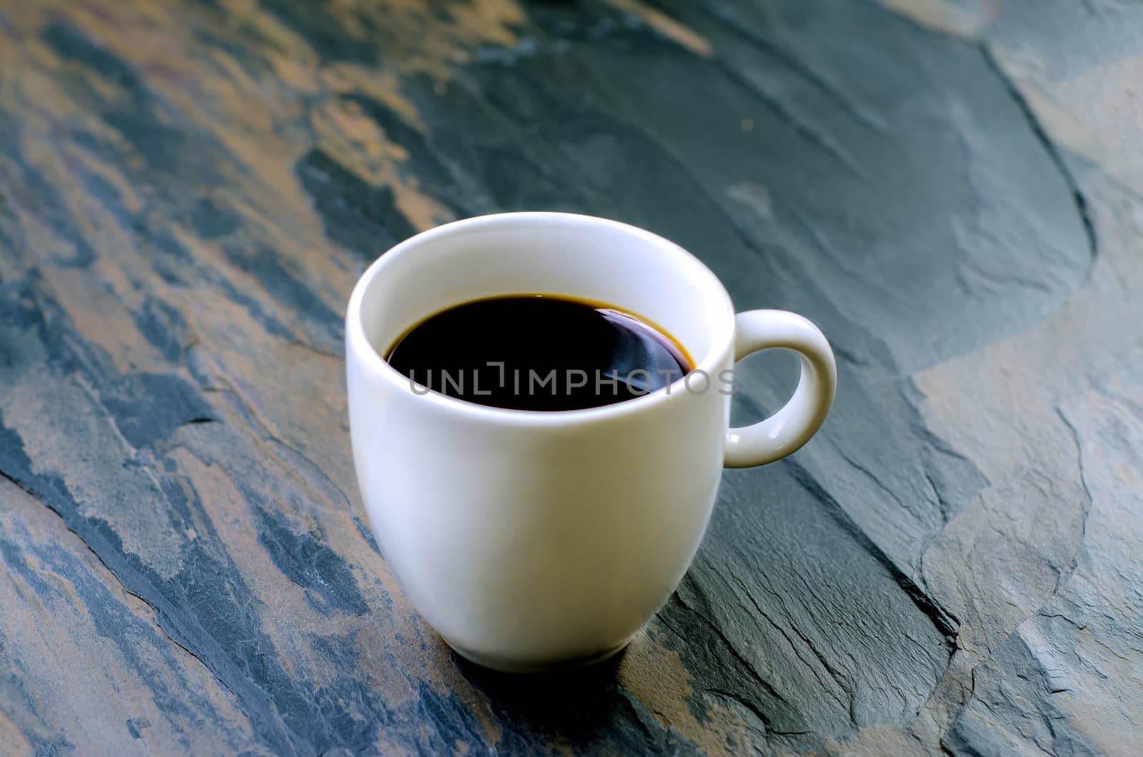 Cup of fresh coffee  on stone table