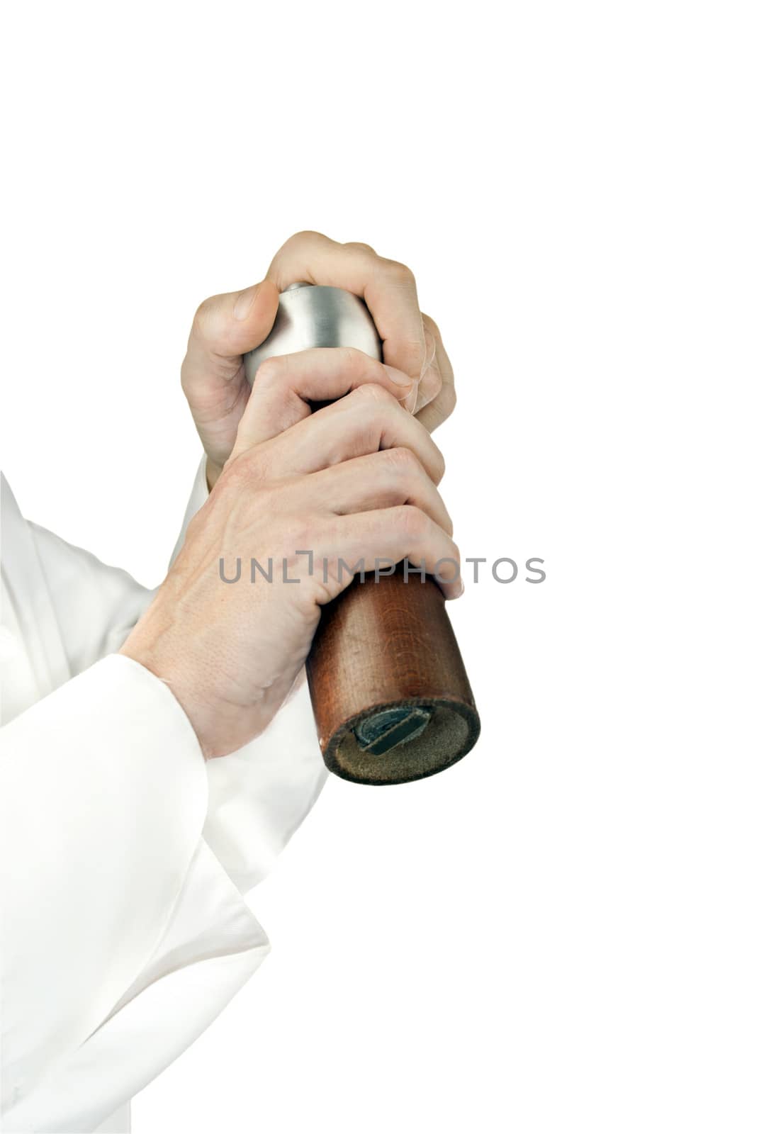 Close-up of a chef using a pepper mill to season his food; side facing, arms only.