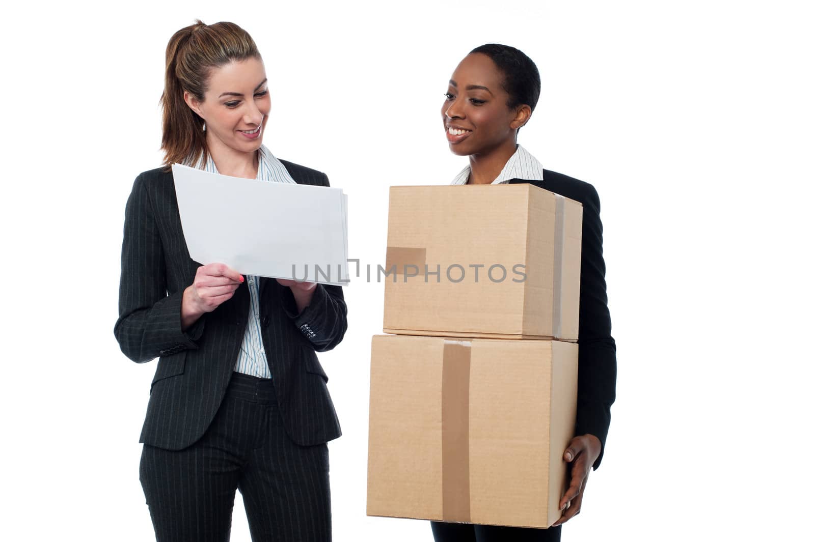 Two female workers discussing stock details by stockyimages