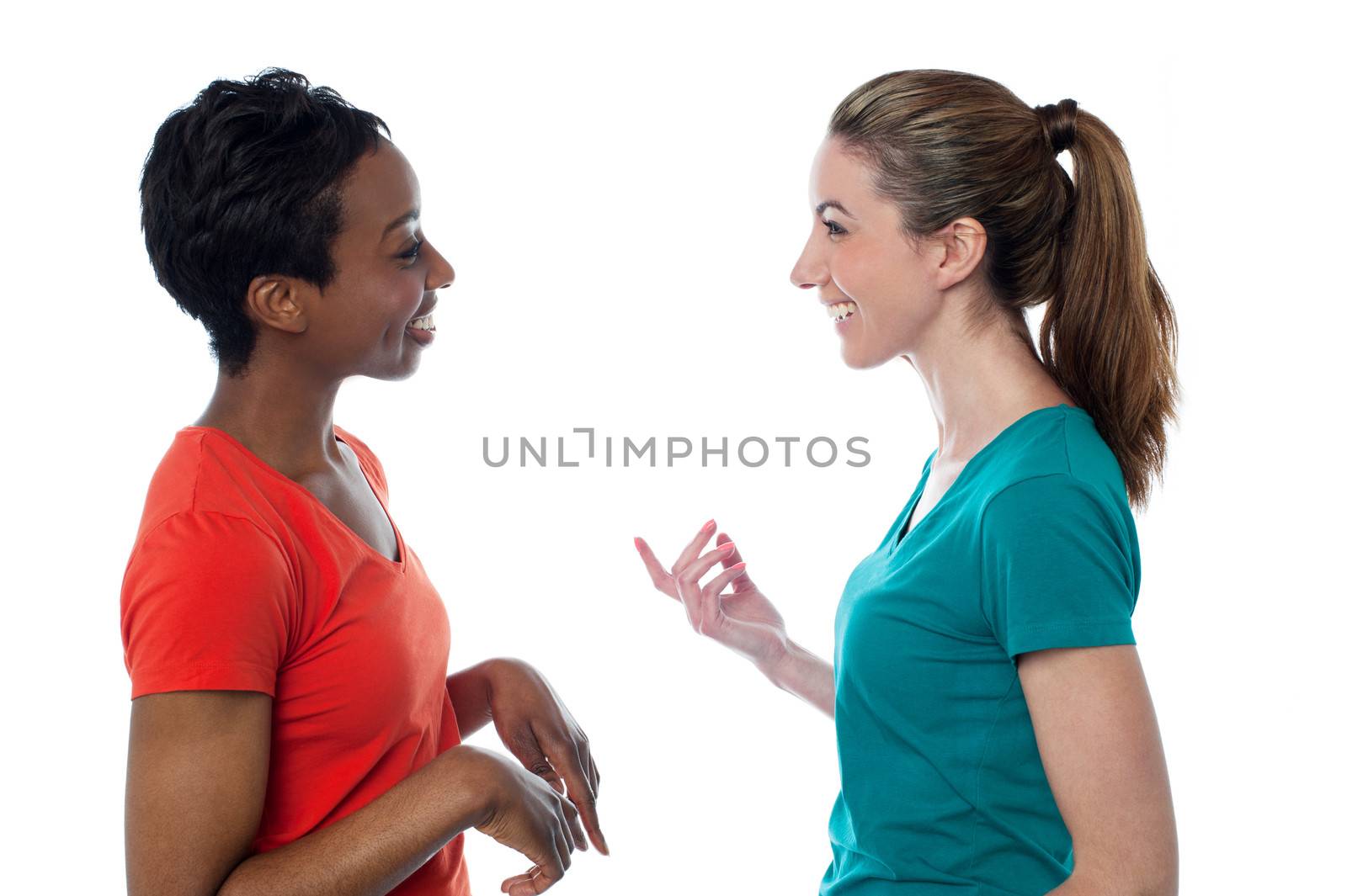 Pretty women having a discussion by stockyimages