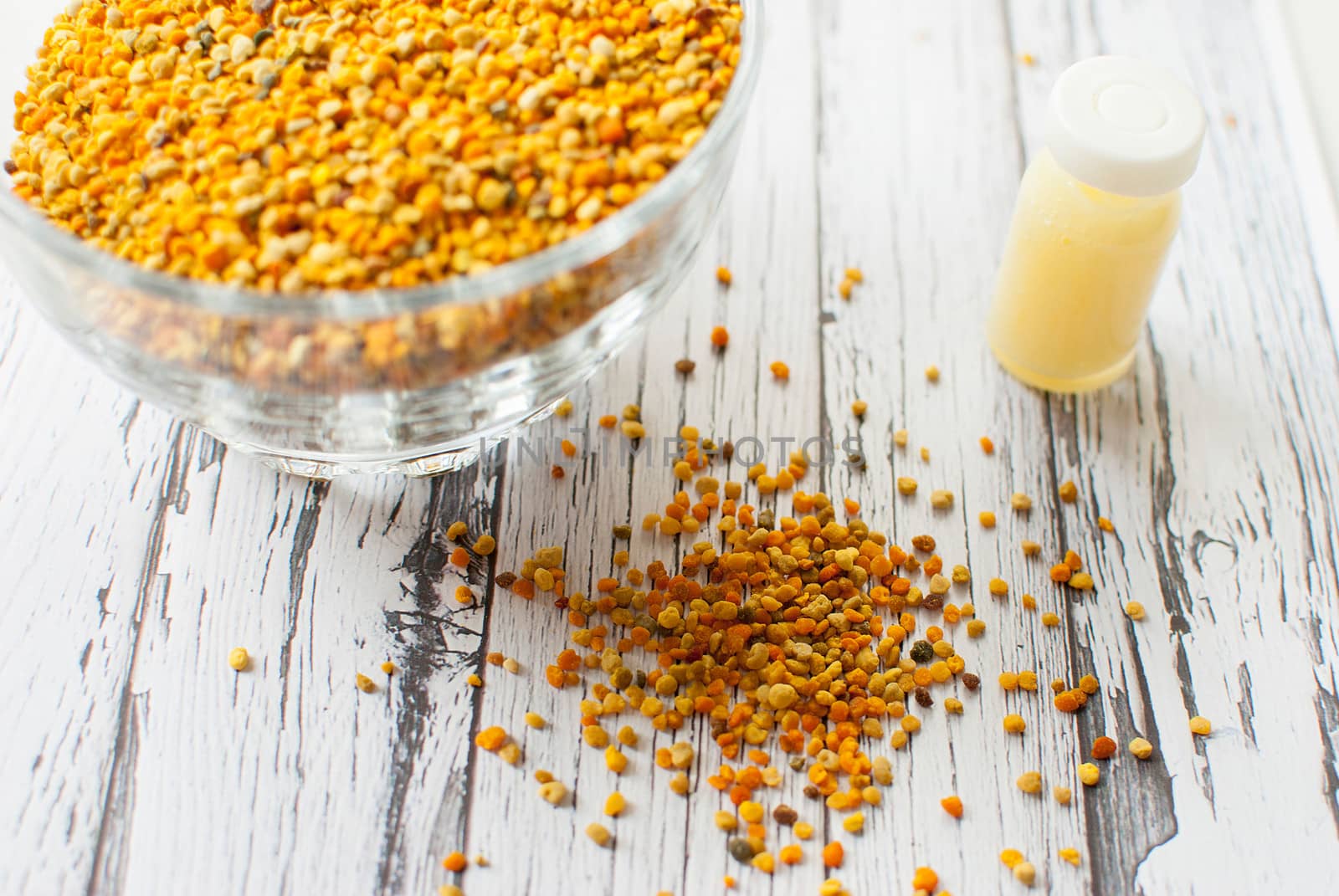 raw organic bee pollen over wooden board