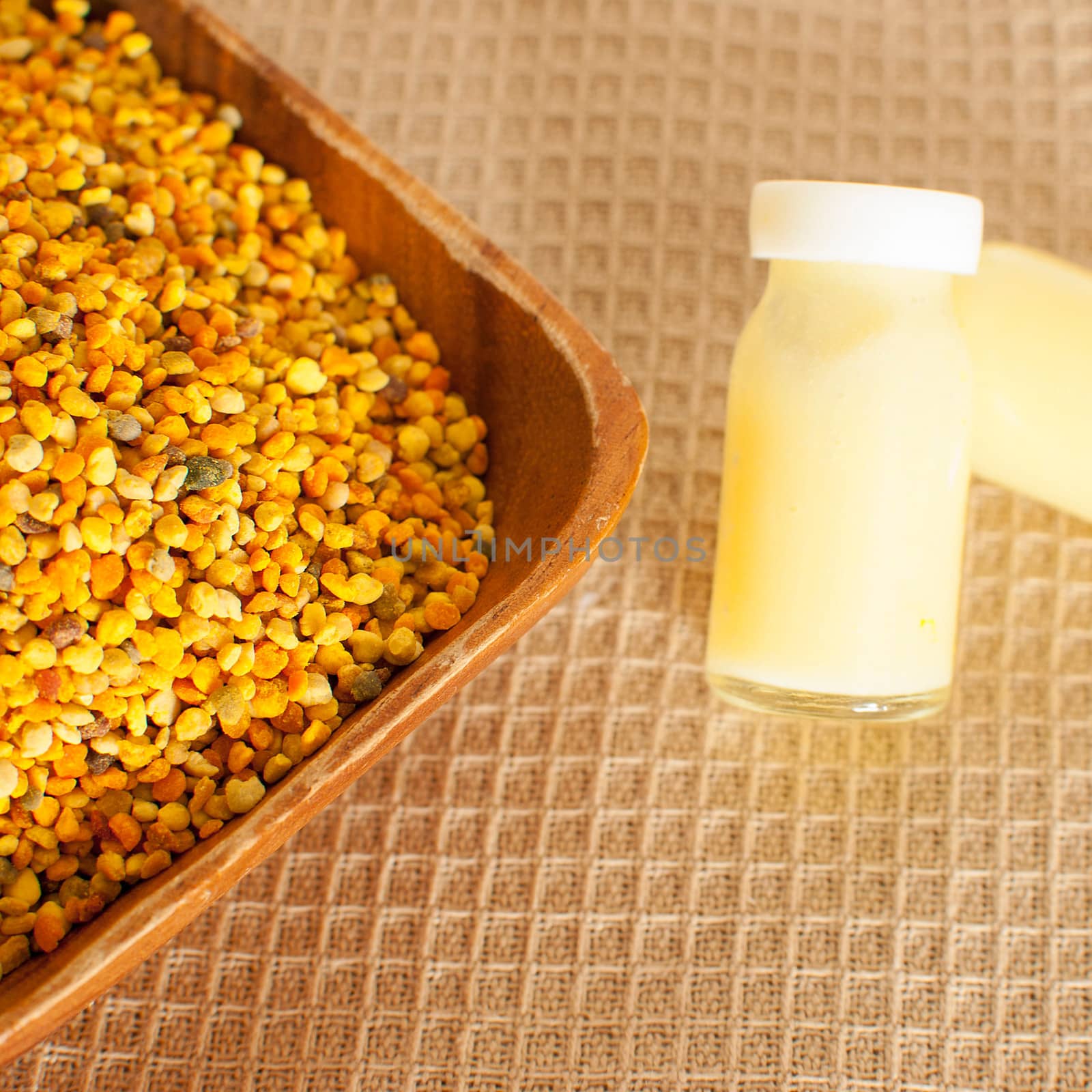 raw organic bee pollen over wooden board