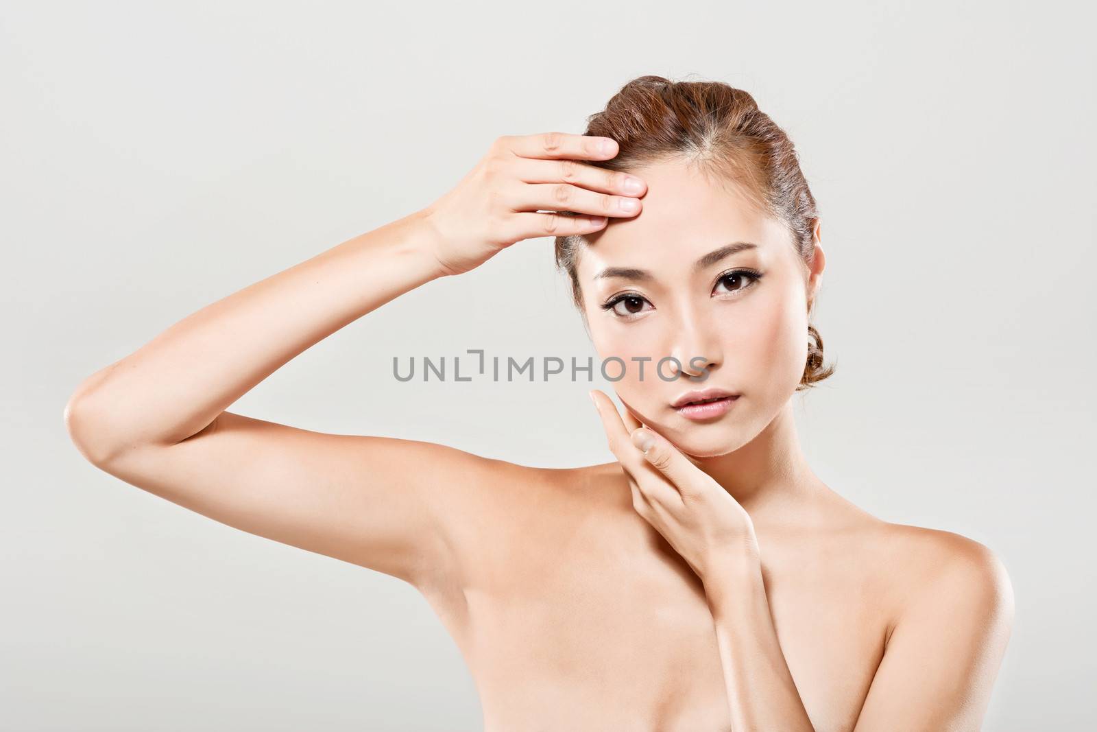 Asian beauty face closeup portrait with clean and fresh elegant lady in studio gray background.