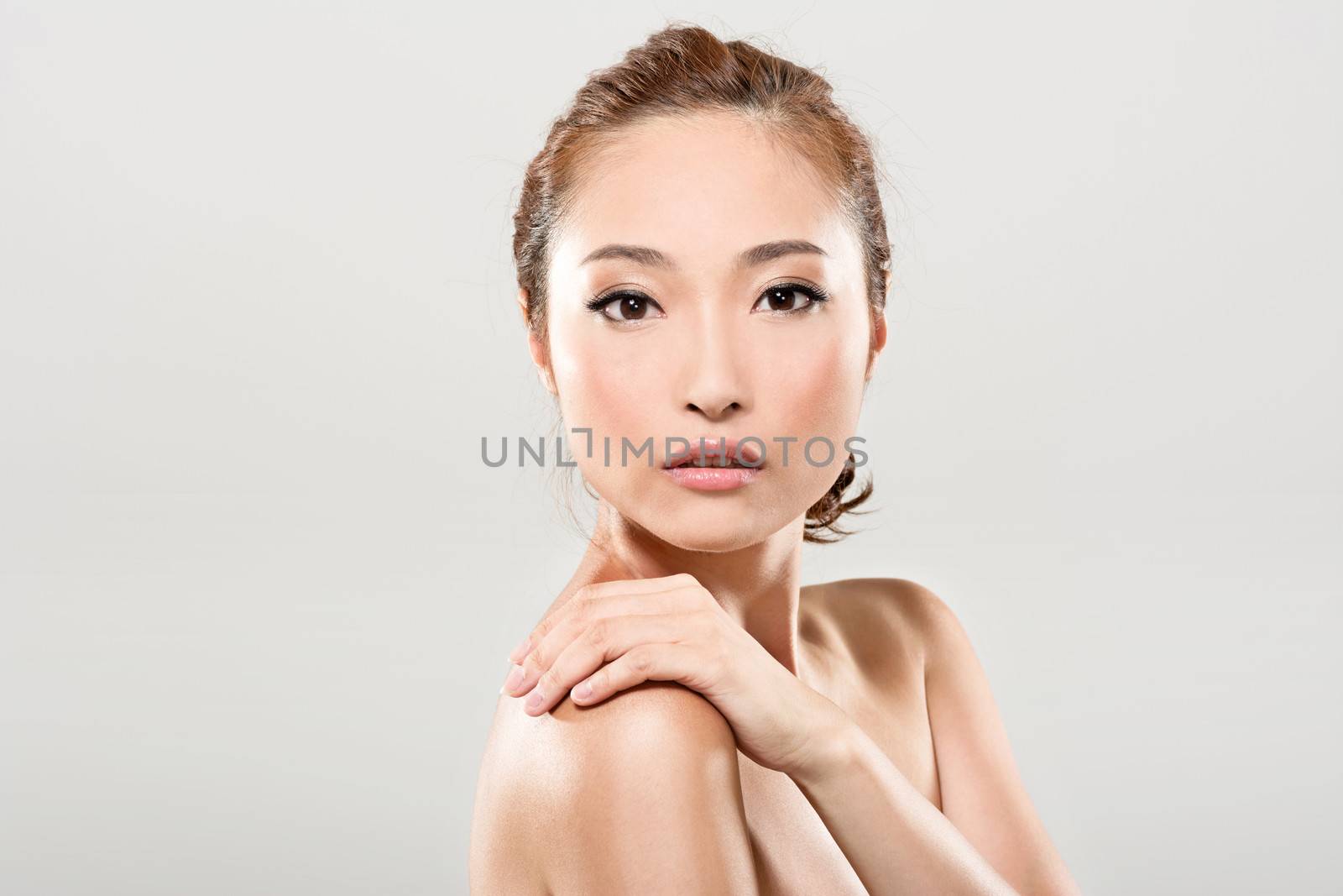 Asian beauty face closeup portrait with clean and fresh elegant lady in studio gray background.