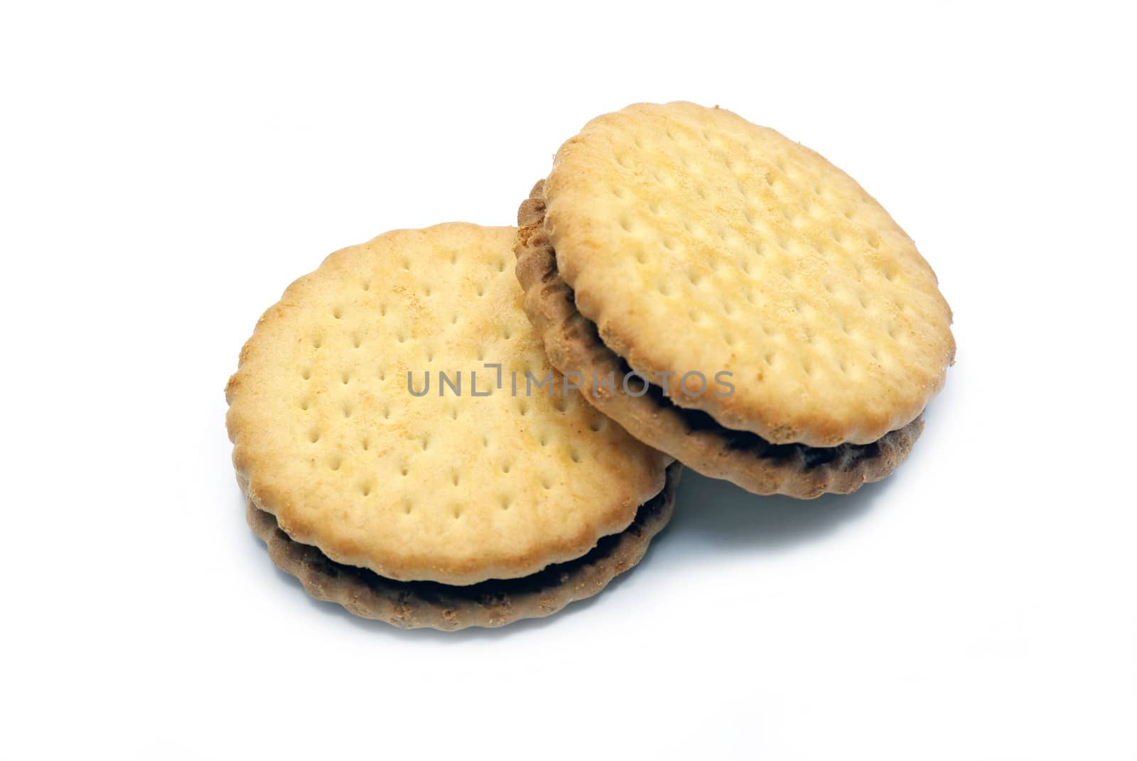 Two biscuits isolated with cocoa cream on a white background.