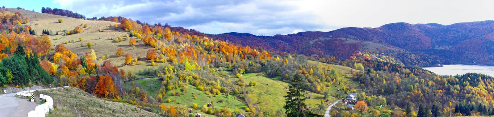 Beautiful autumn panorama with meadows and forest