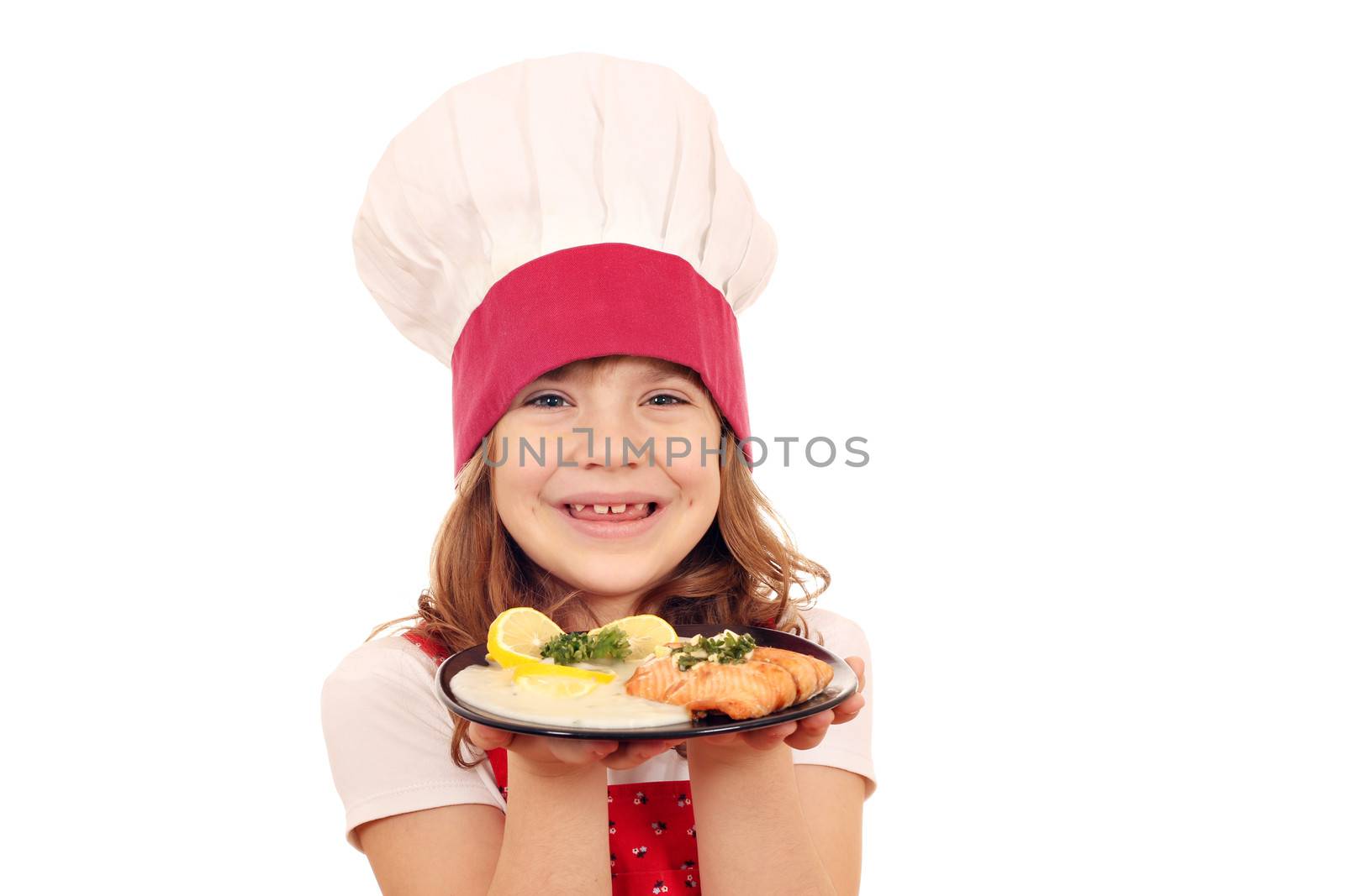 happy little girl cook with salmon fish portion by goce