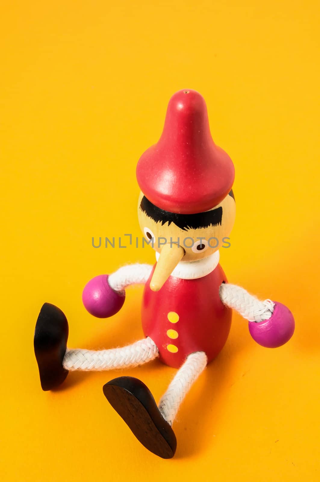 Pinocchio Toy Statue on a Colored Background