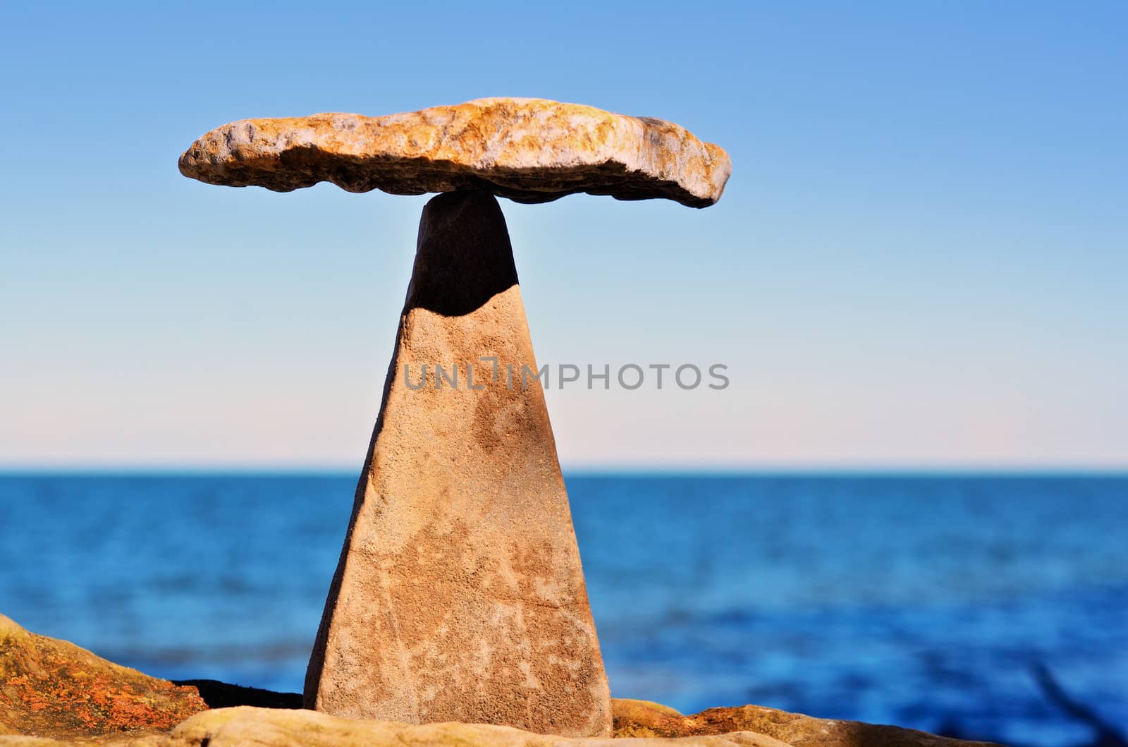 Balancing of pebbles on the top of triangle stone