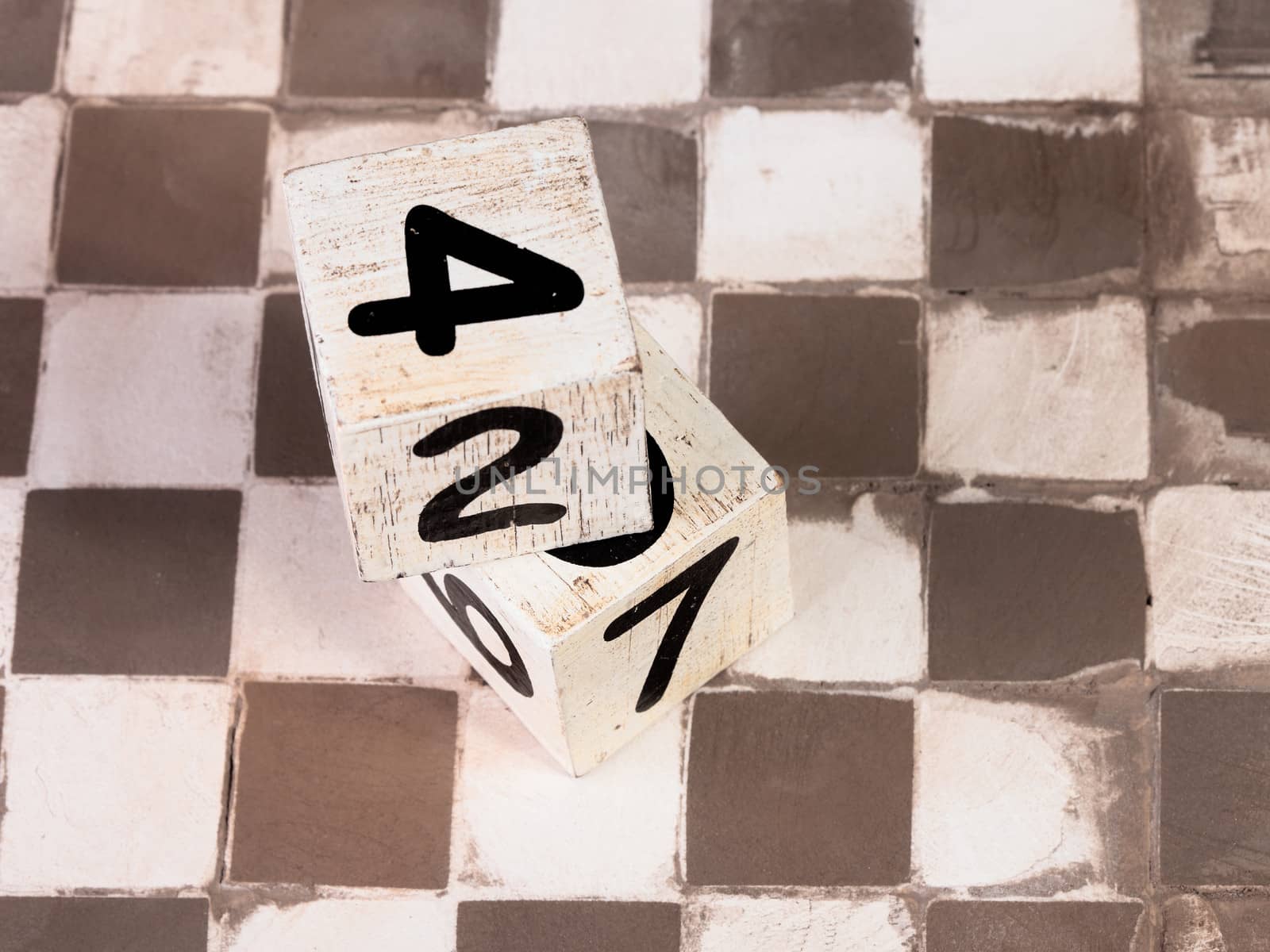 two dices on a tiles floor