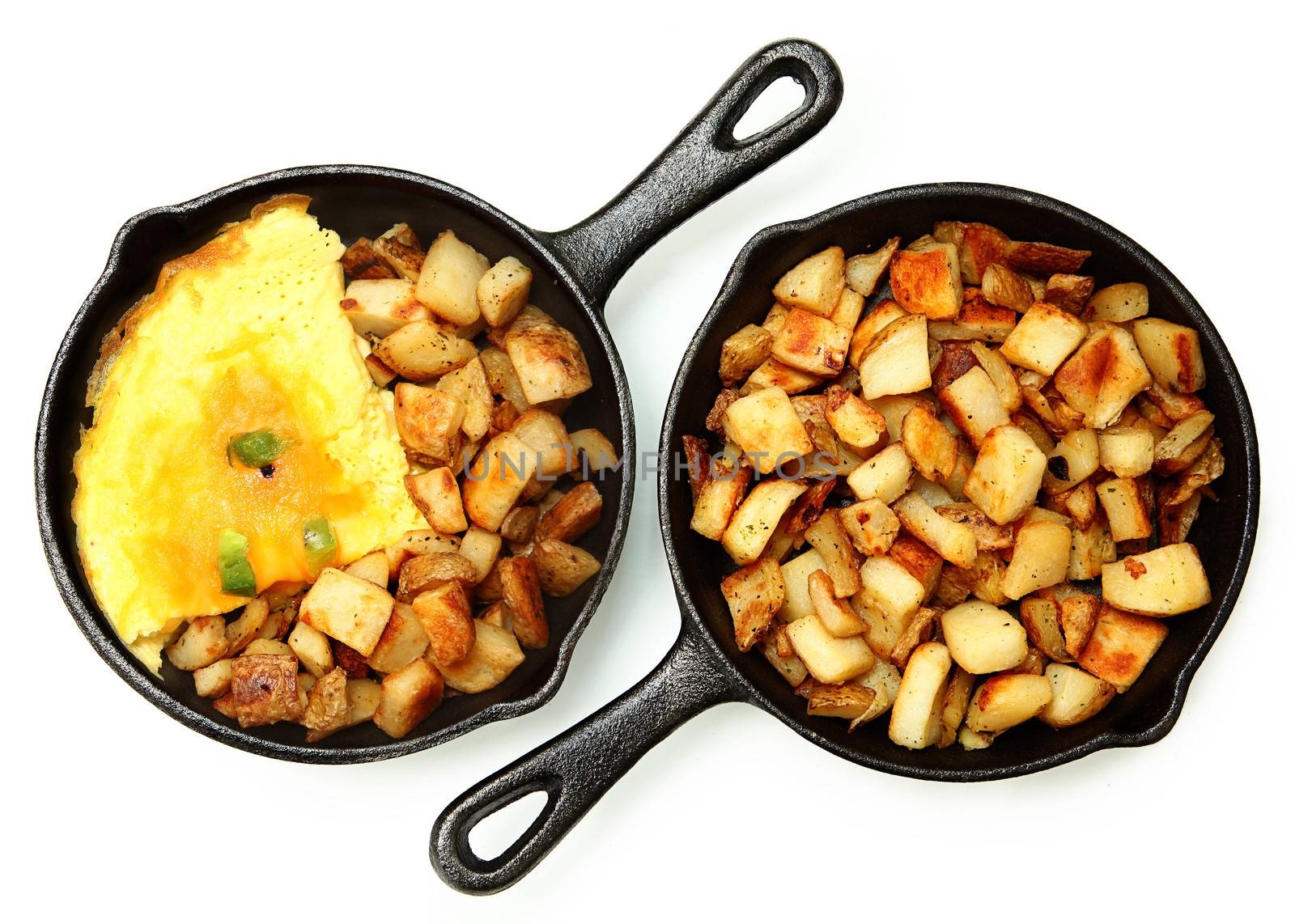 Denver Omelette and Ranch Potatoes in Cast Iron Skillet Isolated by duplass