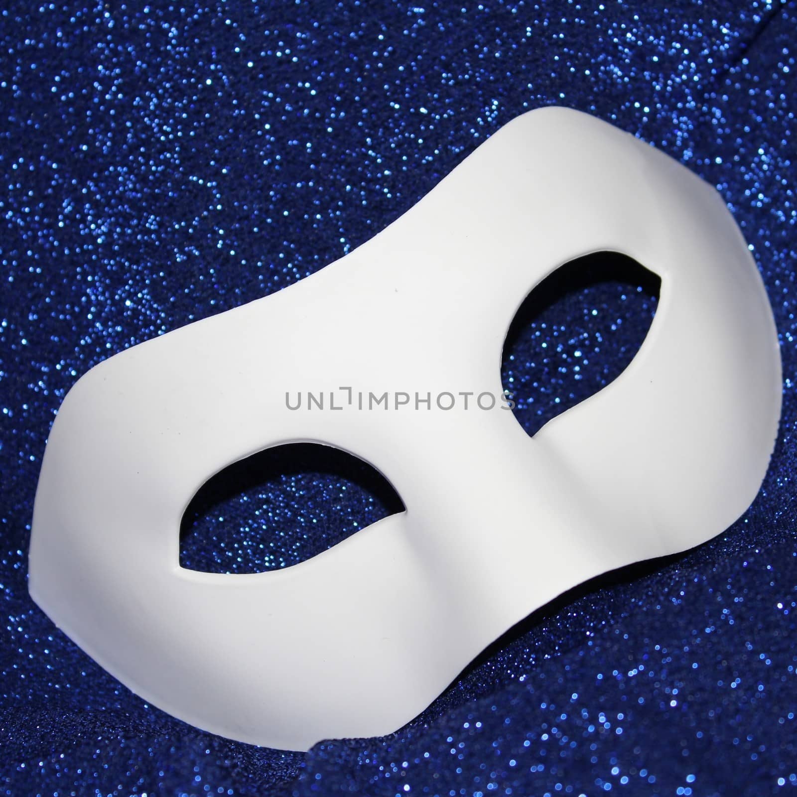 white mask on blue glitters