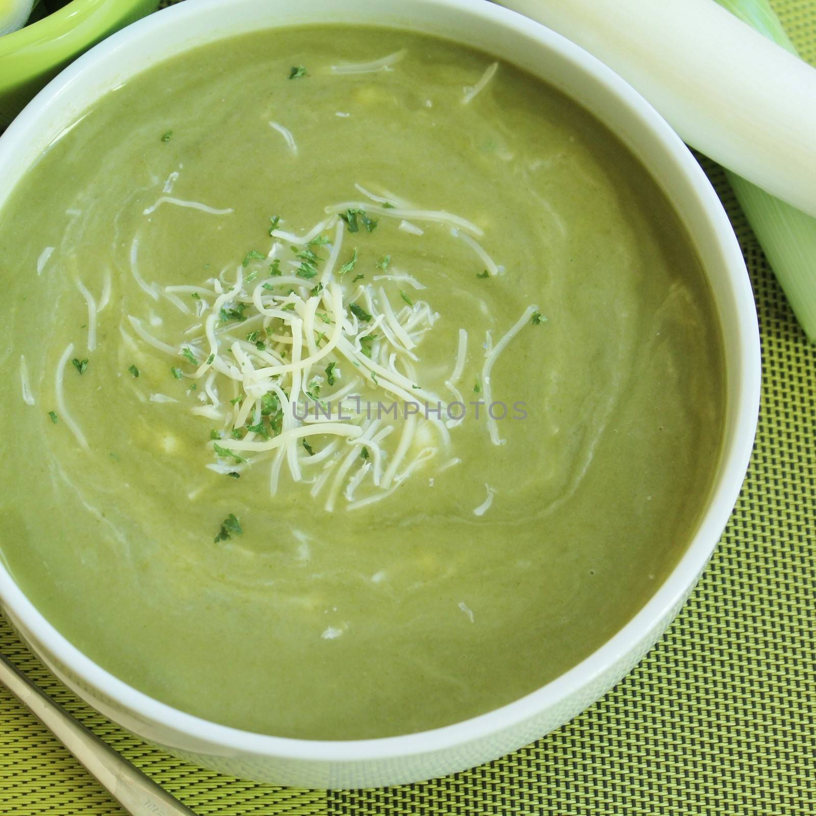 Bowl of soup green with cheese