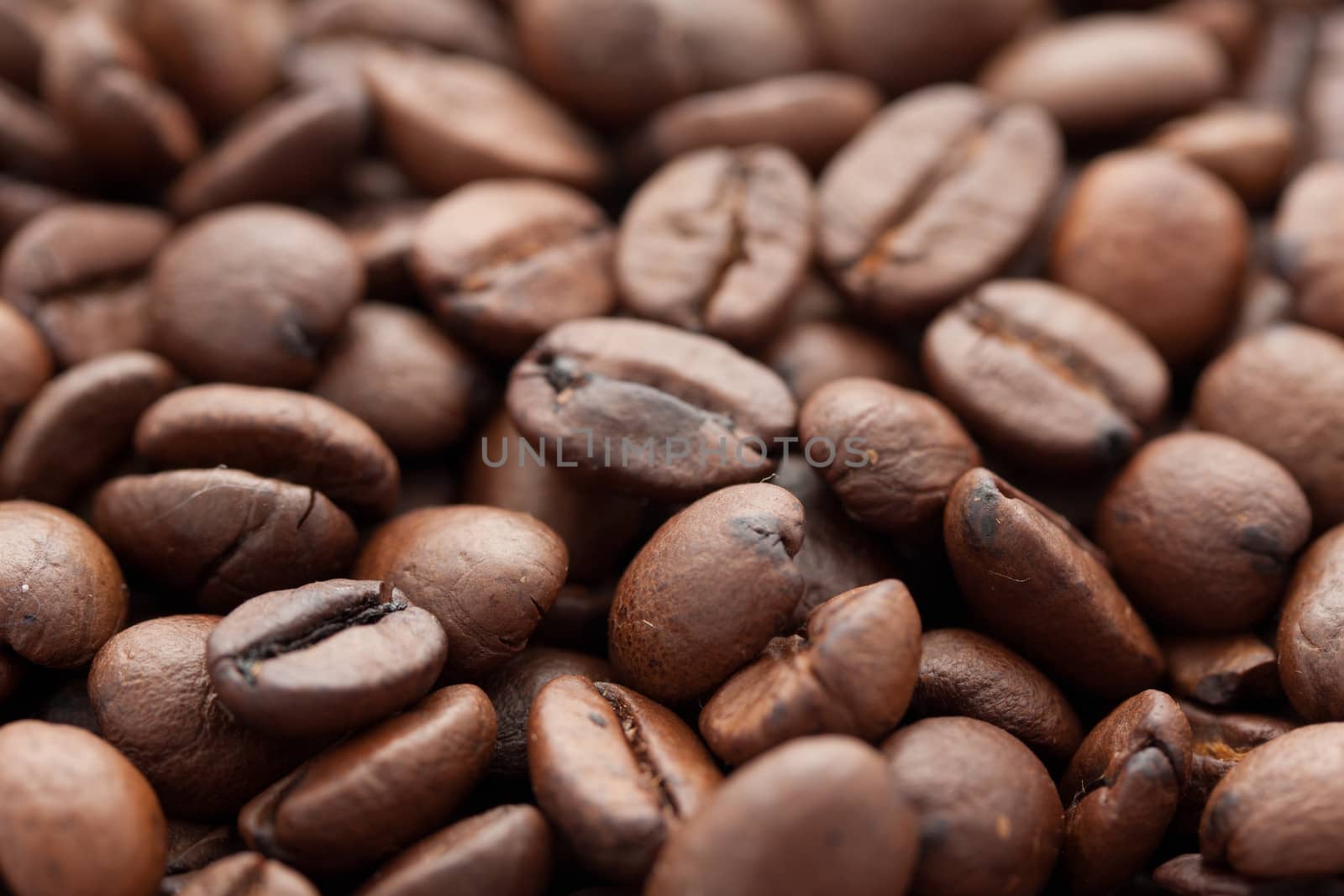 Close-up of brown coffee beans, background texture