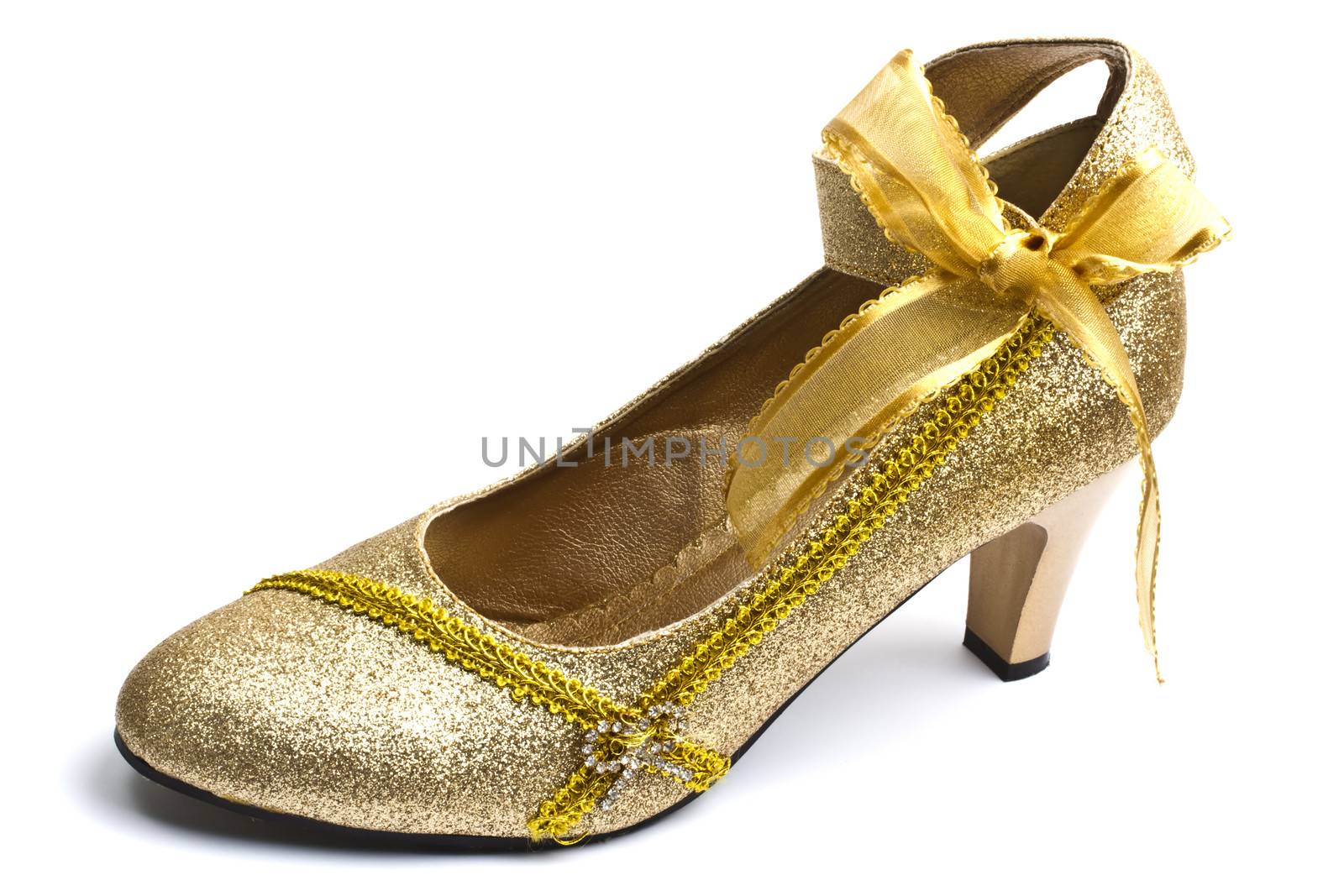 Beautiful golden shoe isolated on white