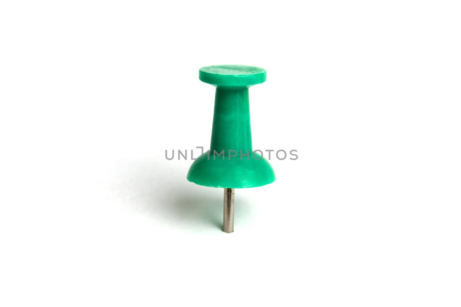 Green push pin isolated on white background 
