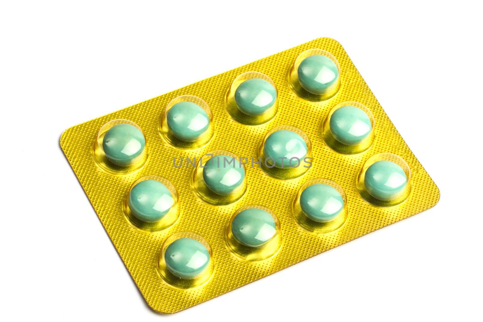 Package of green pills isolated on white background 