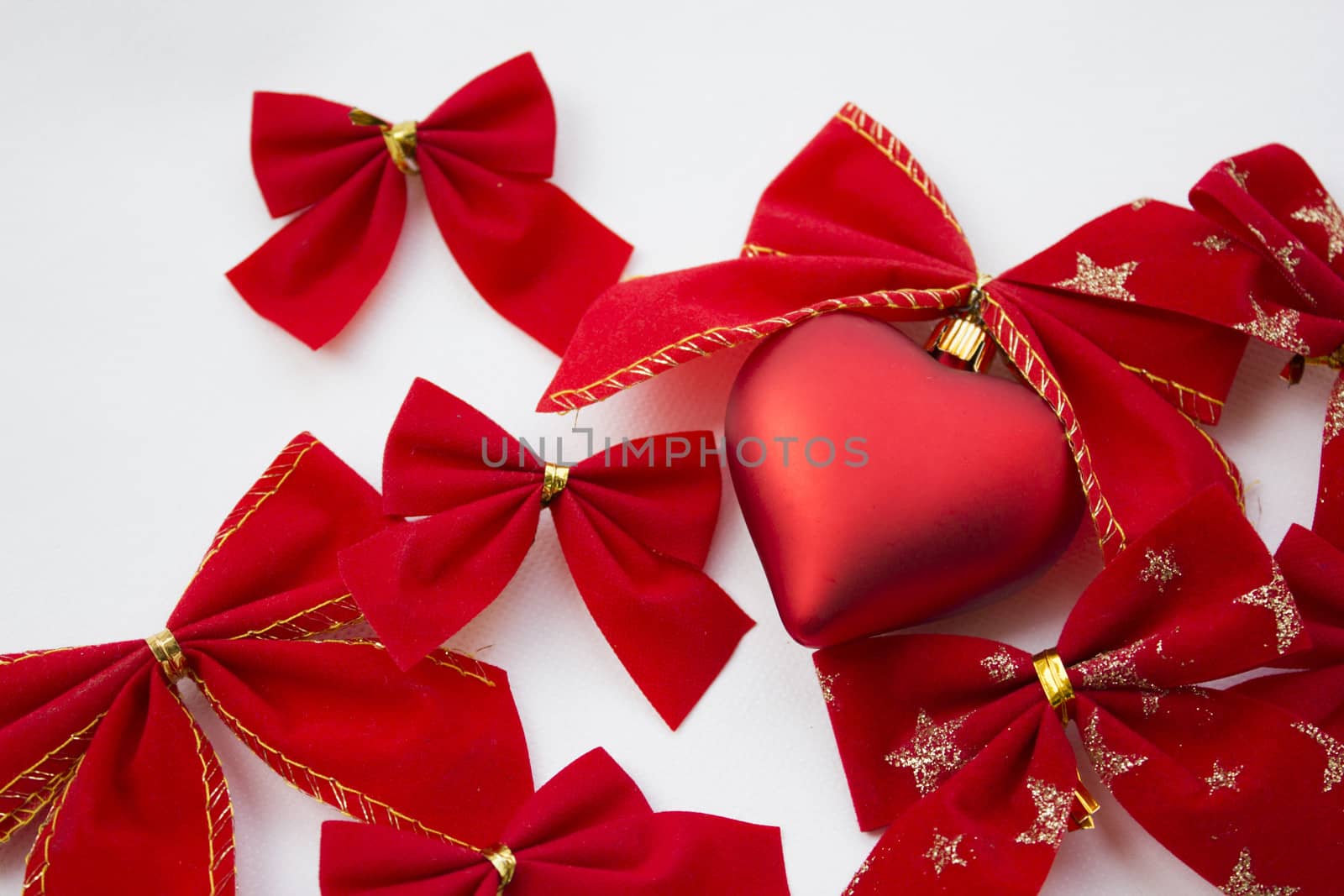 Heart shaped decoration with ribbons around it.