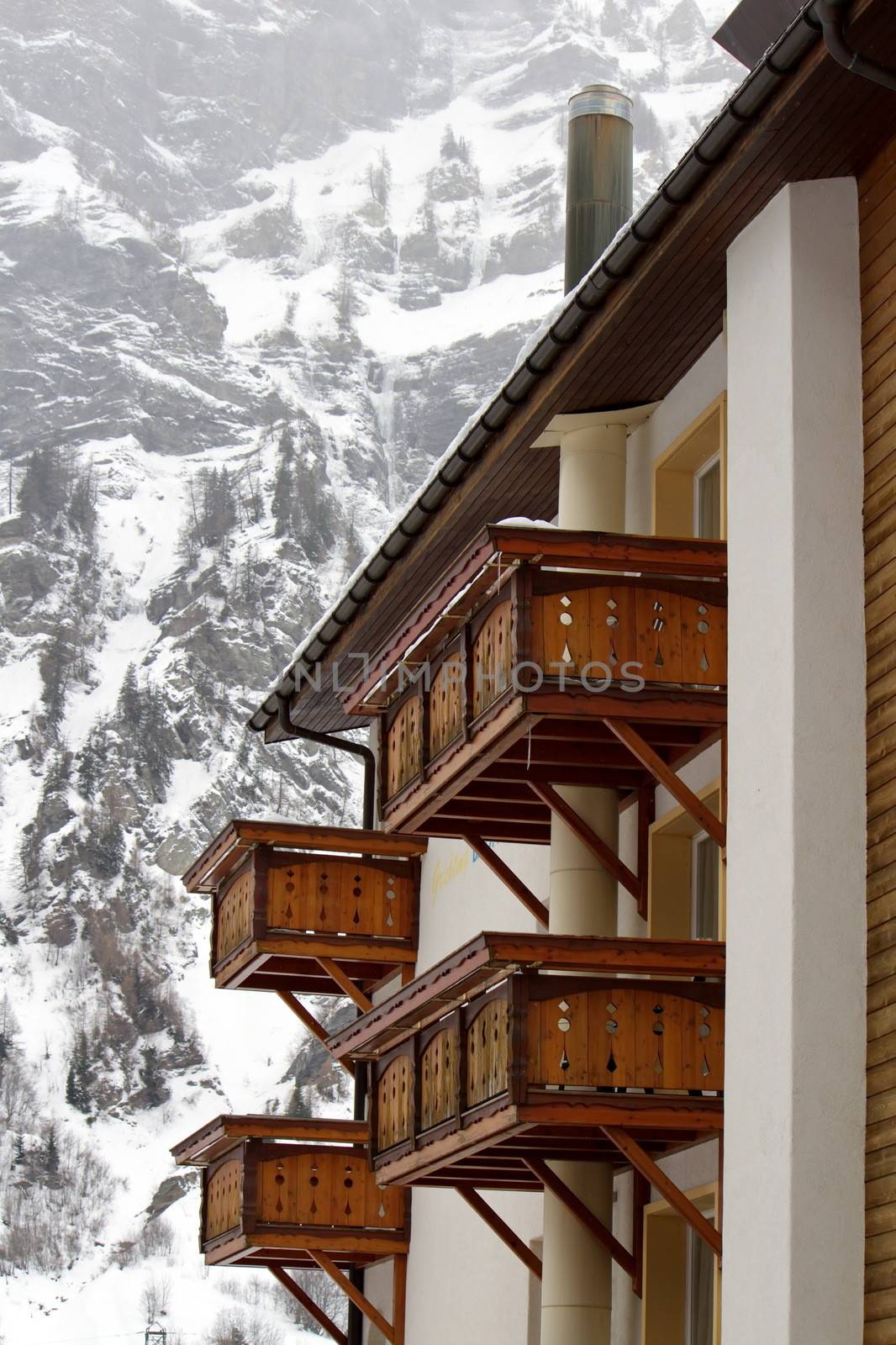 Close up on wooden balconies of a chalet at Loeche les bains in winter, Switzerland