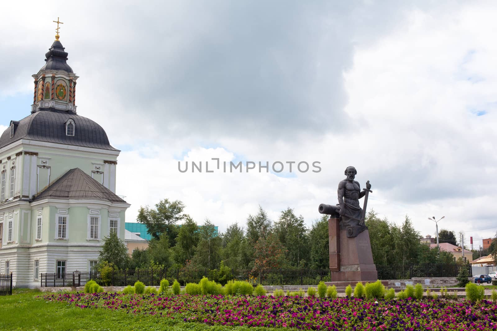 White and green orthodox church and monument
