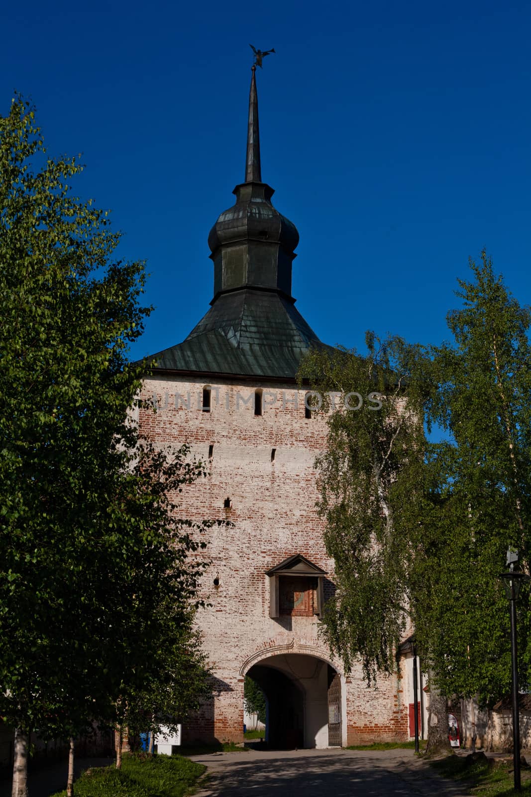 A big white tower with small gate
