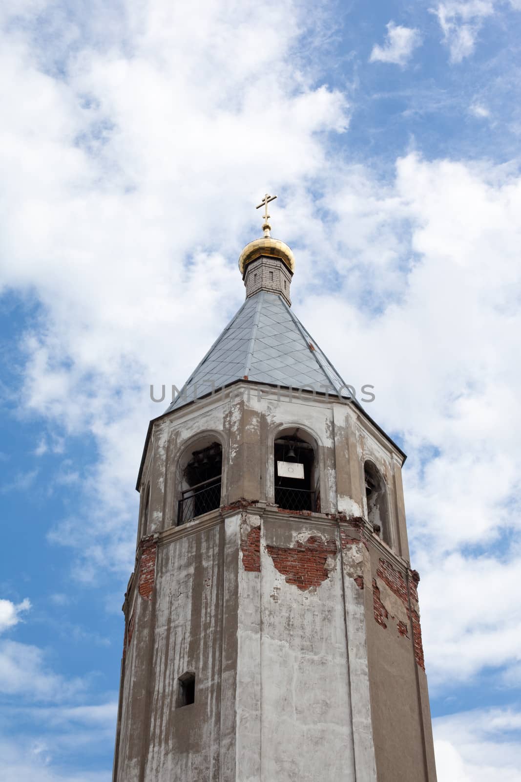 Brick red orthodox church with one golden dome
