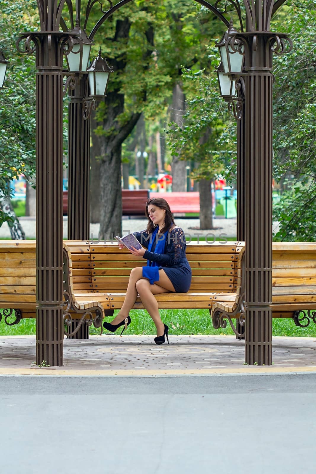 Girl reading book in the park by dedmorozz