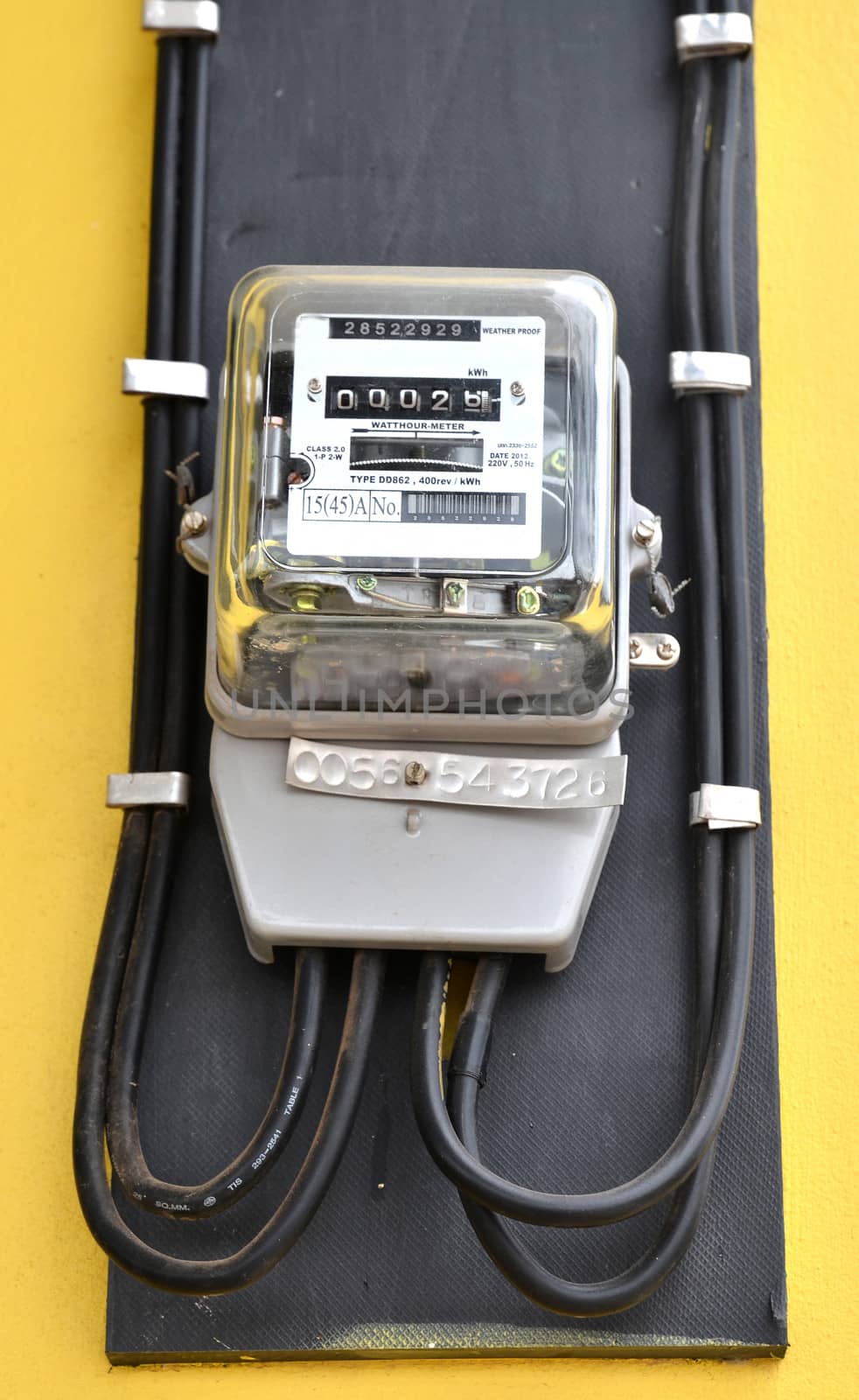 watthour meter on yellow wall