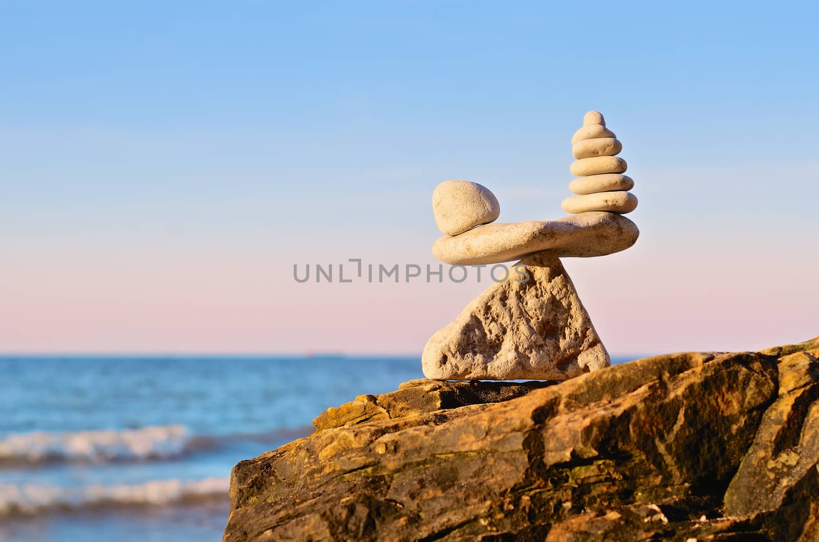 Balancing of pebbles on the top of triangle stone