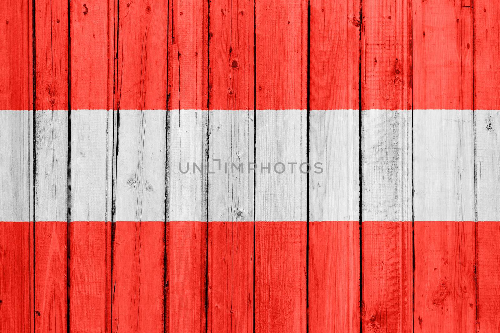 The Austrian flag painted on a wooden fence