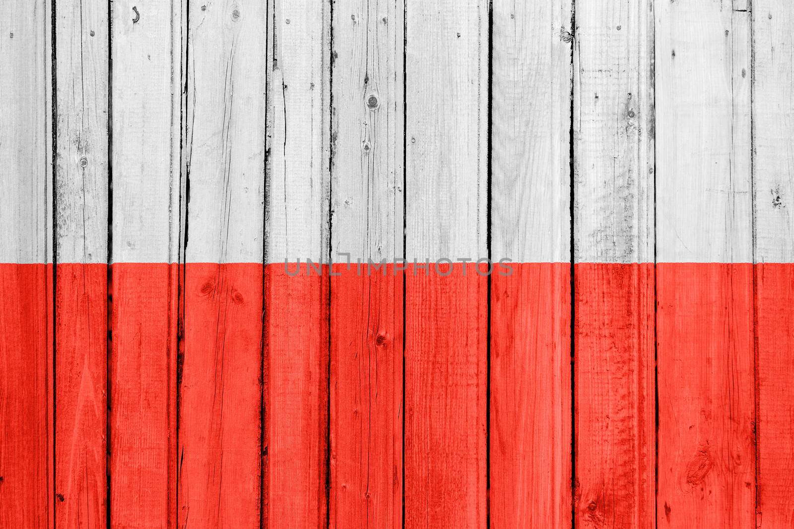 The Polish flag painted on a wooden fence