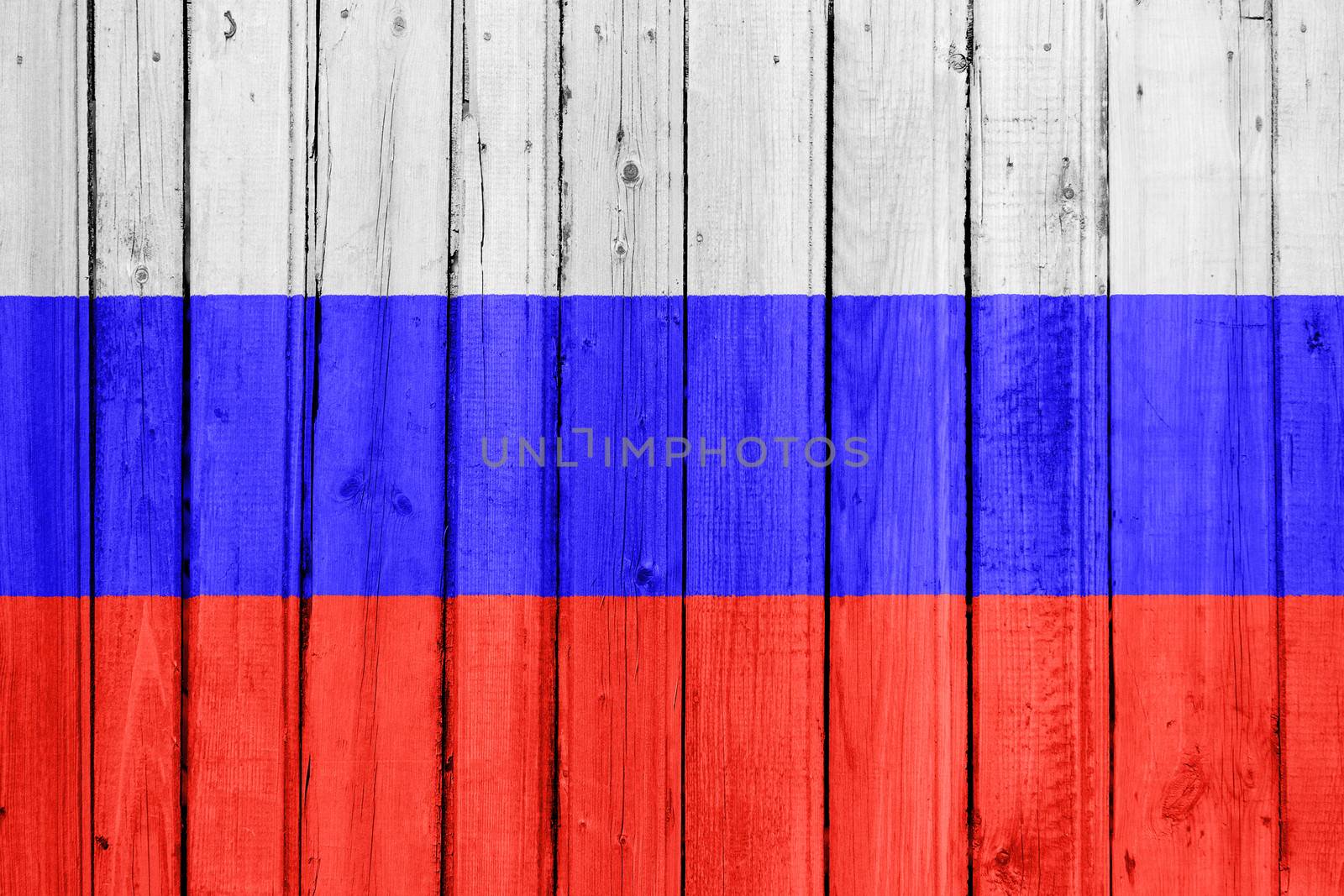 The Russian flag painted on a wooden fence