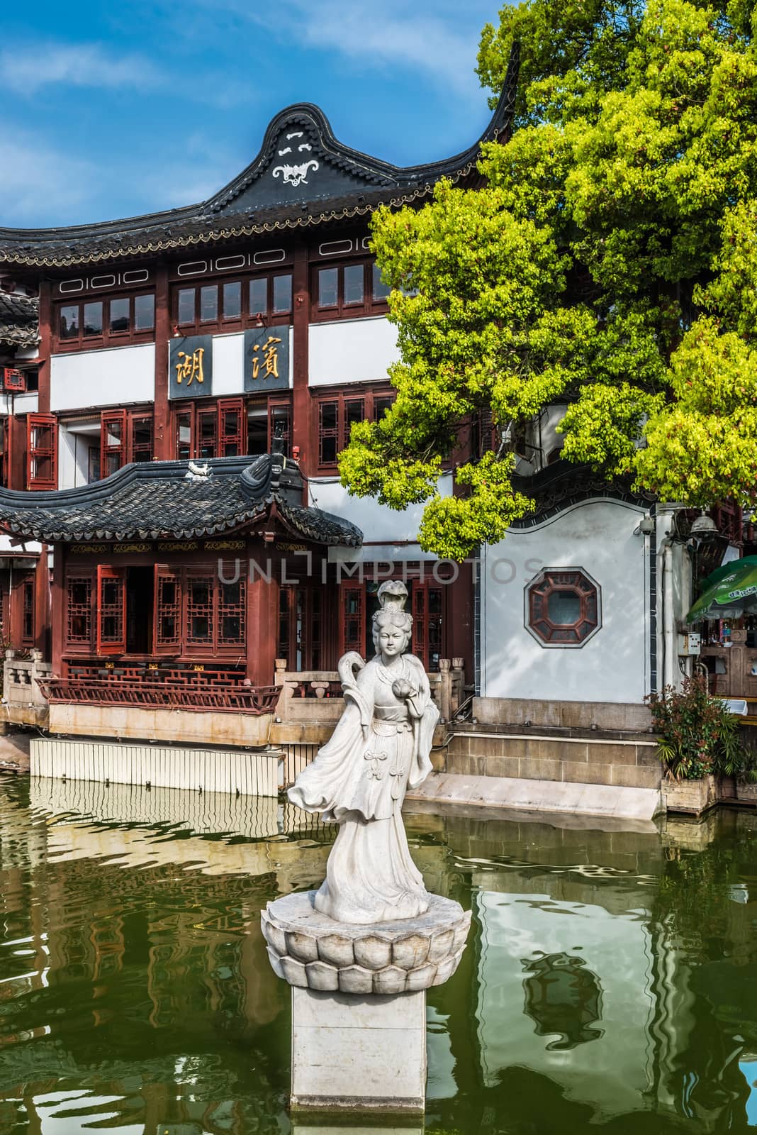 ancient statue on a pond in Fang Bang Zhong Lu old city shanghai china