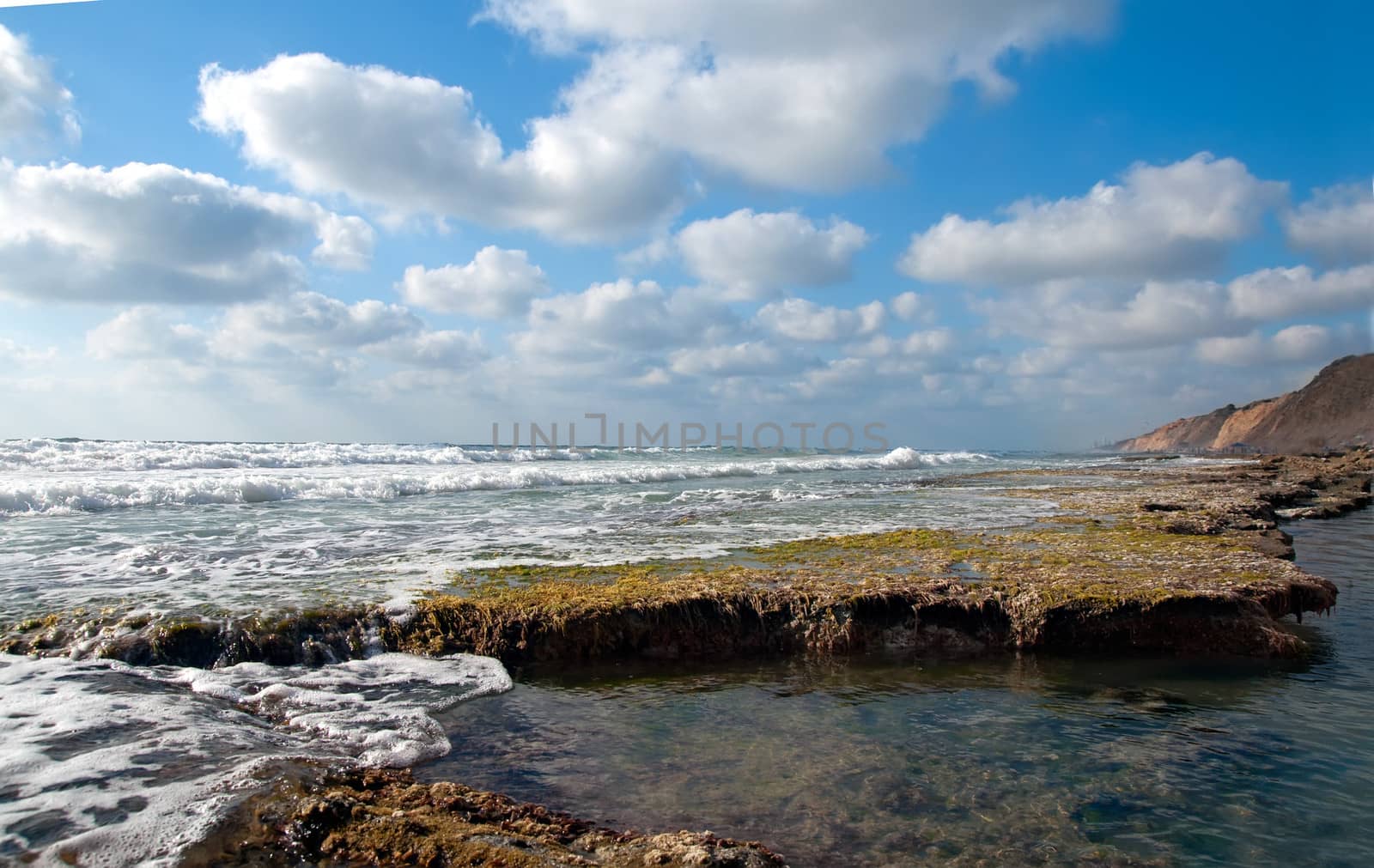 Landscape of the rocky coast, cloudy sky background