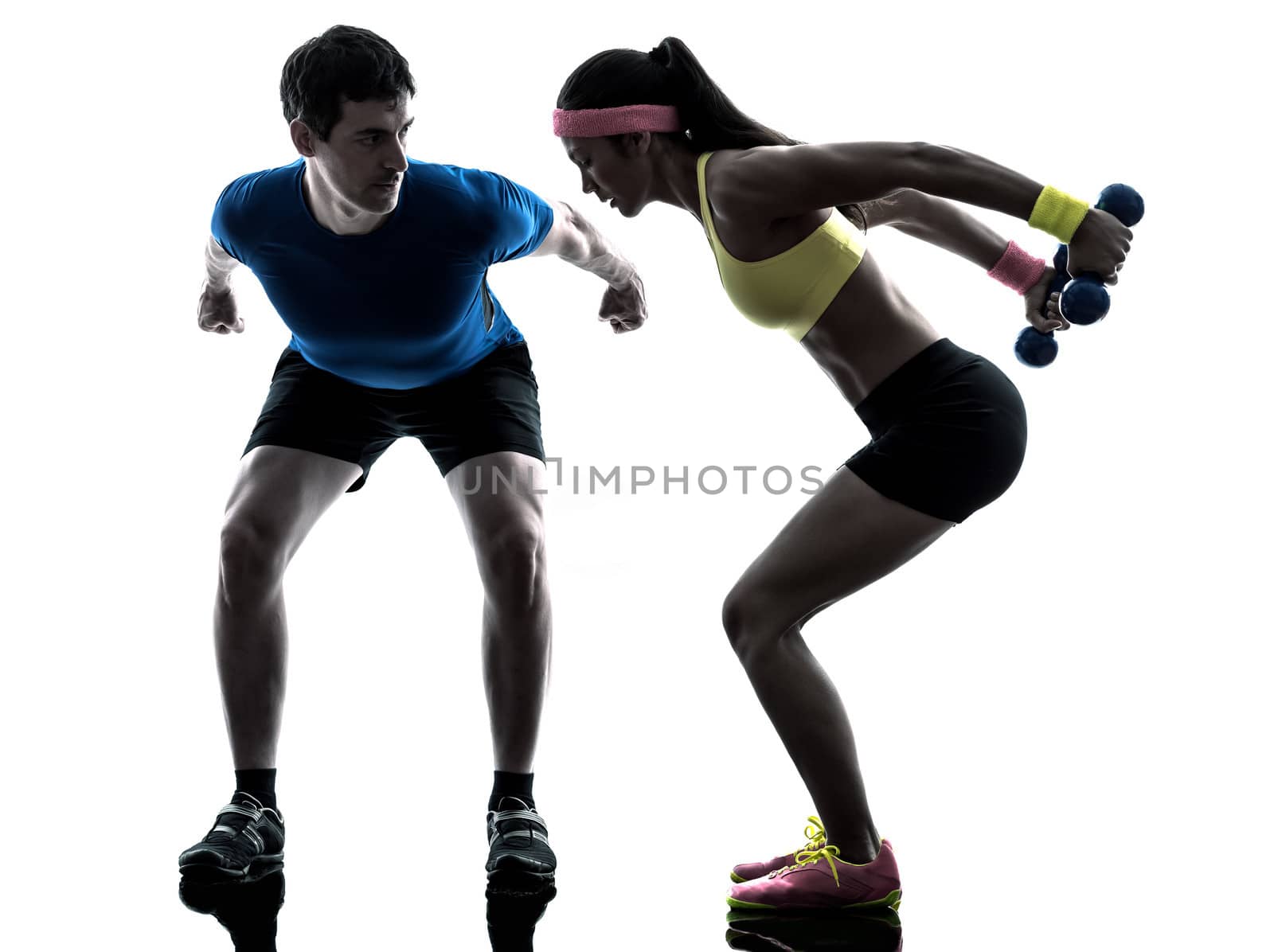 one woman exercising fitness weight training with man coach in silhouette on white background