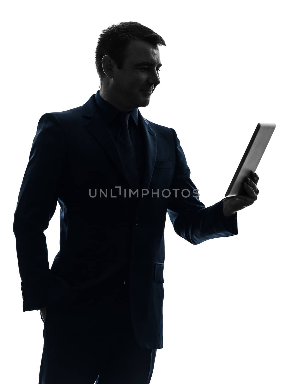 one caucasian business man holding digital tablet smiling in silhouette on white background