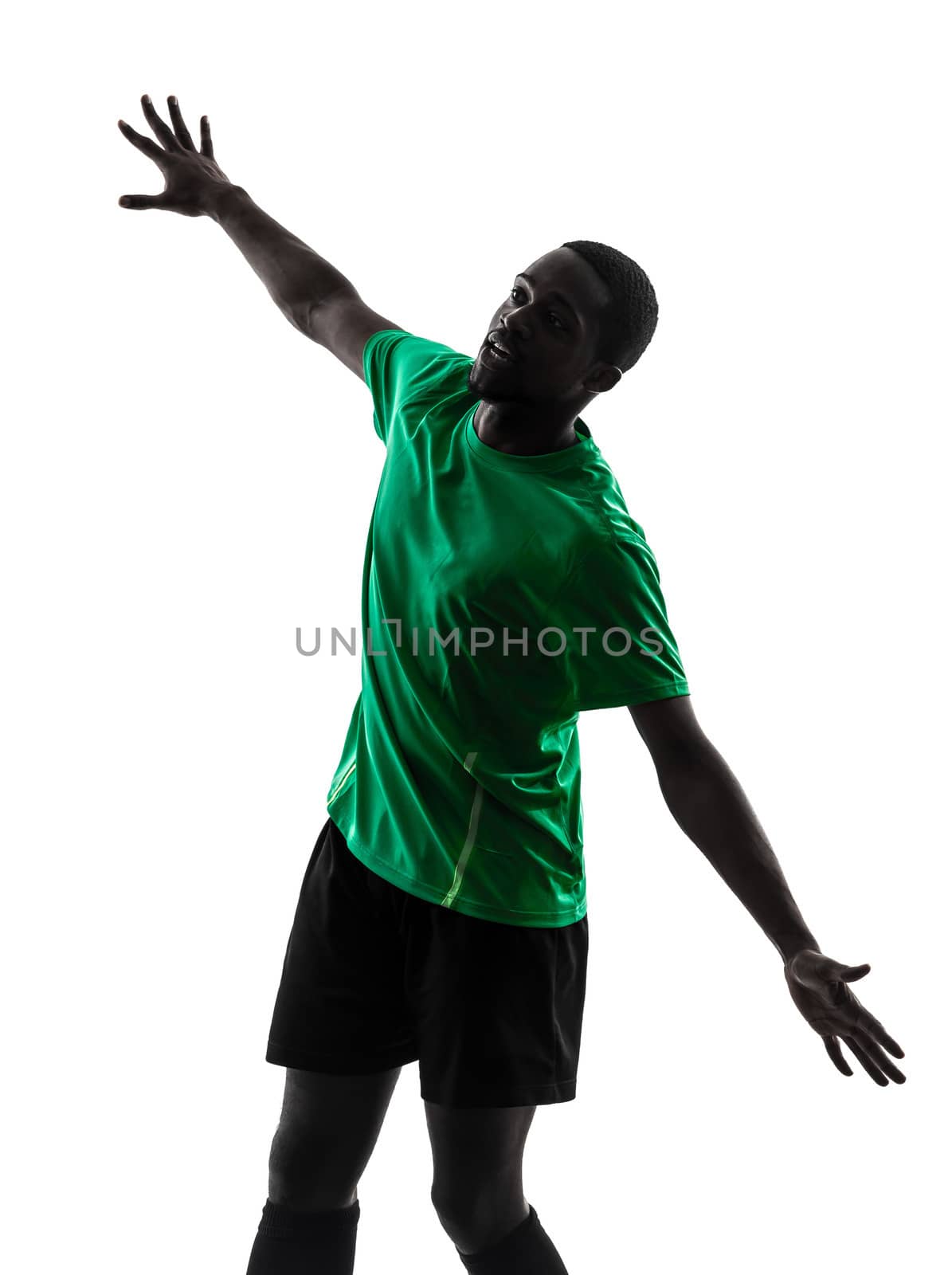one african man soccer player scoring green jersey in silhouette on white background