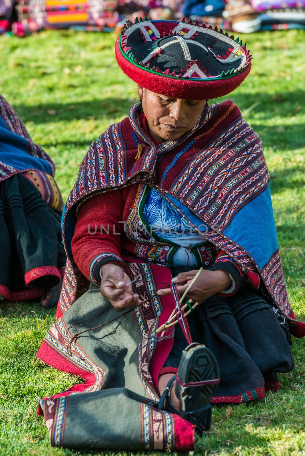 Cuzco, Peru - July 15, 2013: women weaving in the peruvian Andes at Cuzco Peru on july 15th, 2013