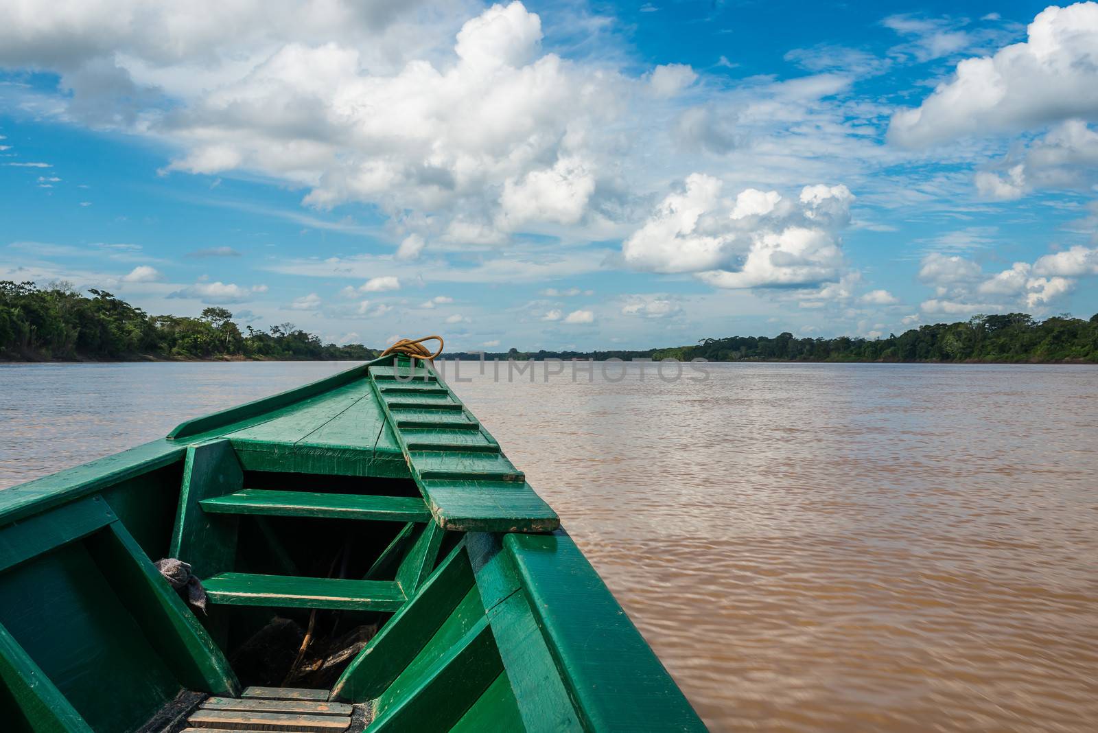 boat in the river in the peruvian Amazon jungle at Madre de Dios by PIXSTILL