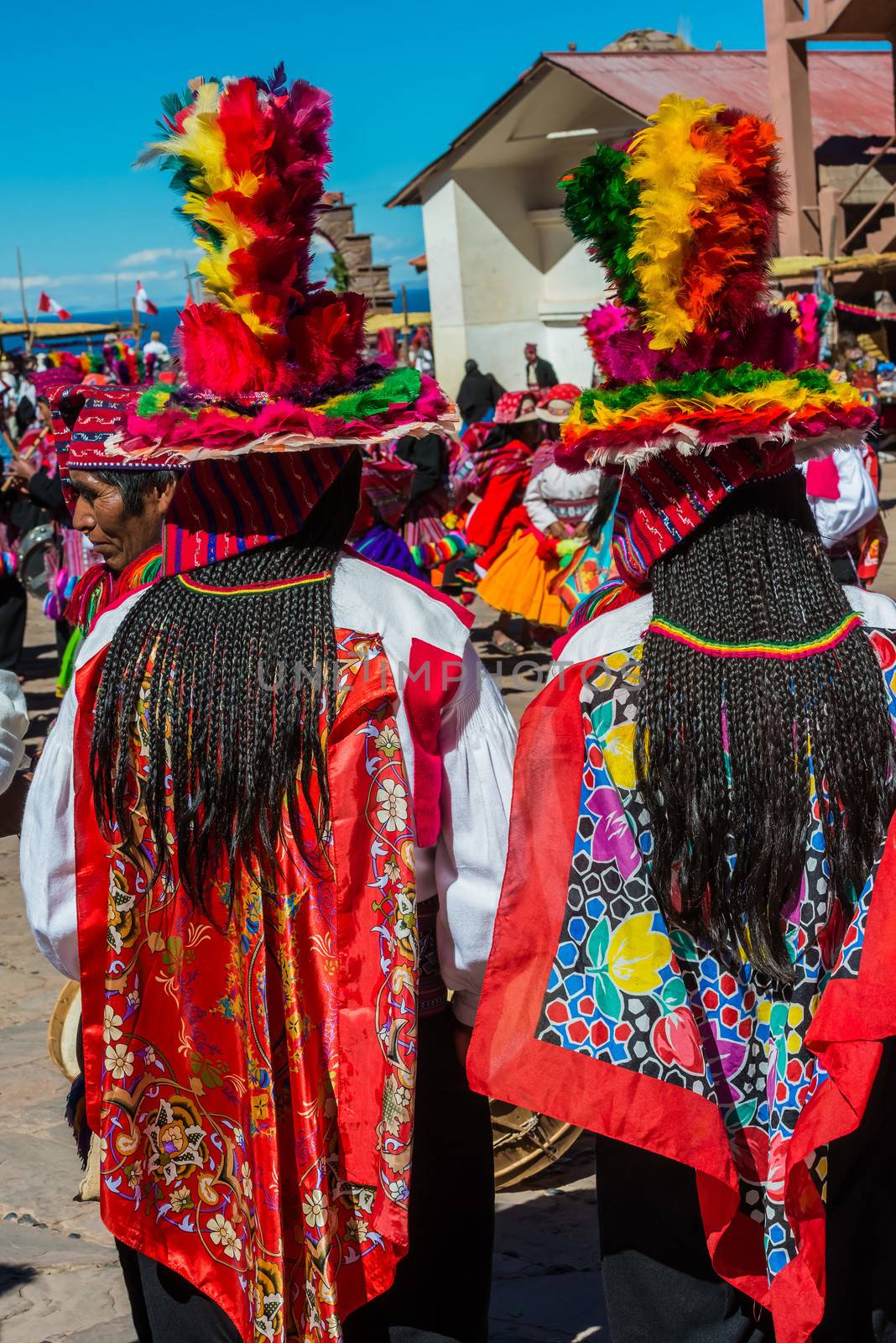 musicians and dancers in the peruvian Andes at Puno Peru by PIXSTILL