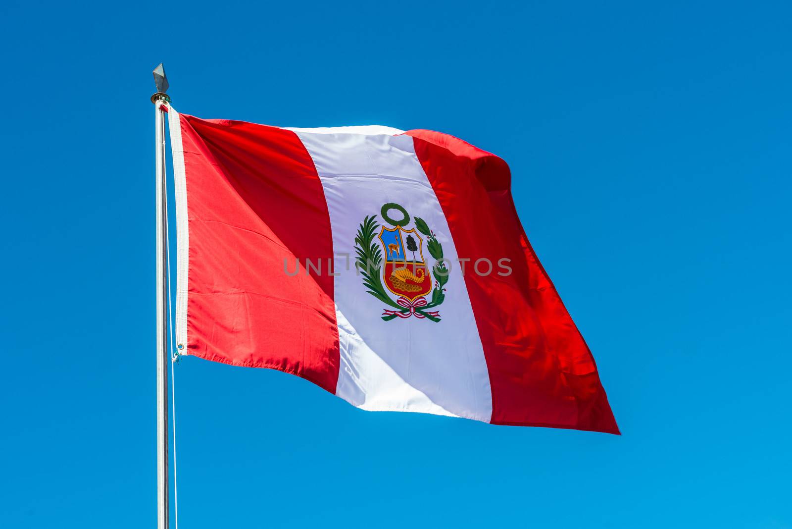 Peruvian Flag in the peruvian Andes at Puno Peru by PIXSTILL