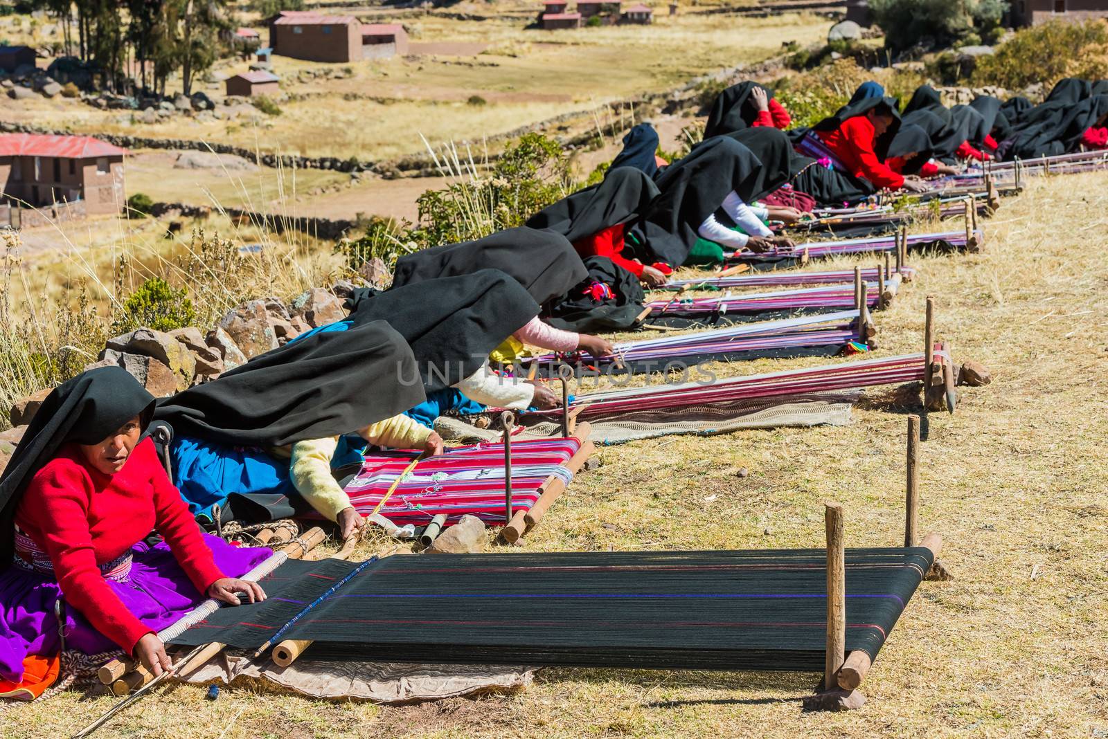 Puno, Peru - July 25, 2013: women weaving in the peruvian Andes at Taquile Island on Puno Peru at july 25th, 2013.