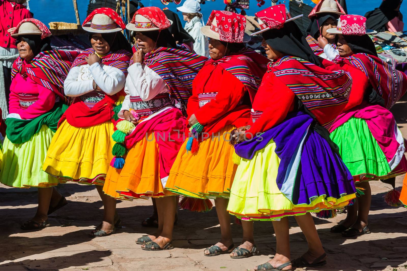 musicians and dancers in the peruvian Andes at Puno Peru by PIXSTILL